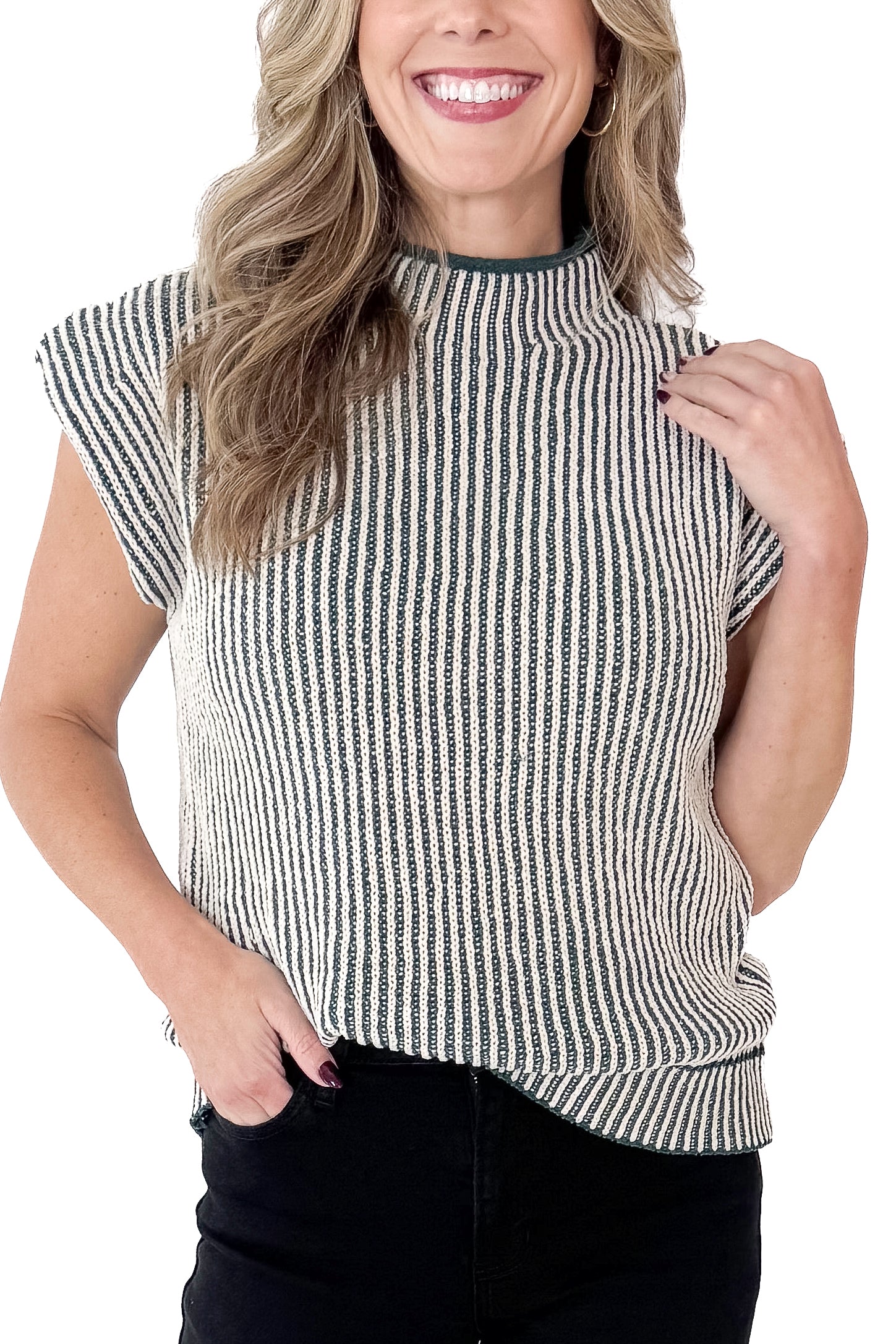 Front detailed view of woman wearing sweater with jeans against white studio background.