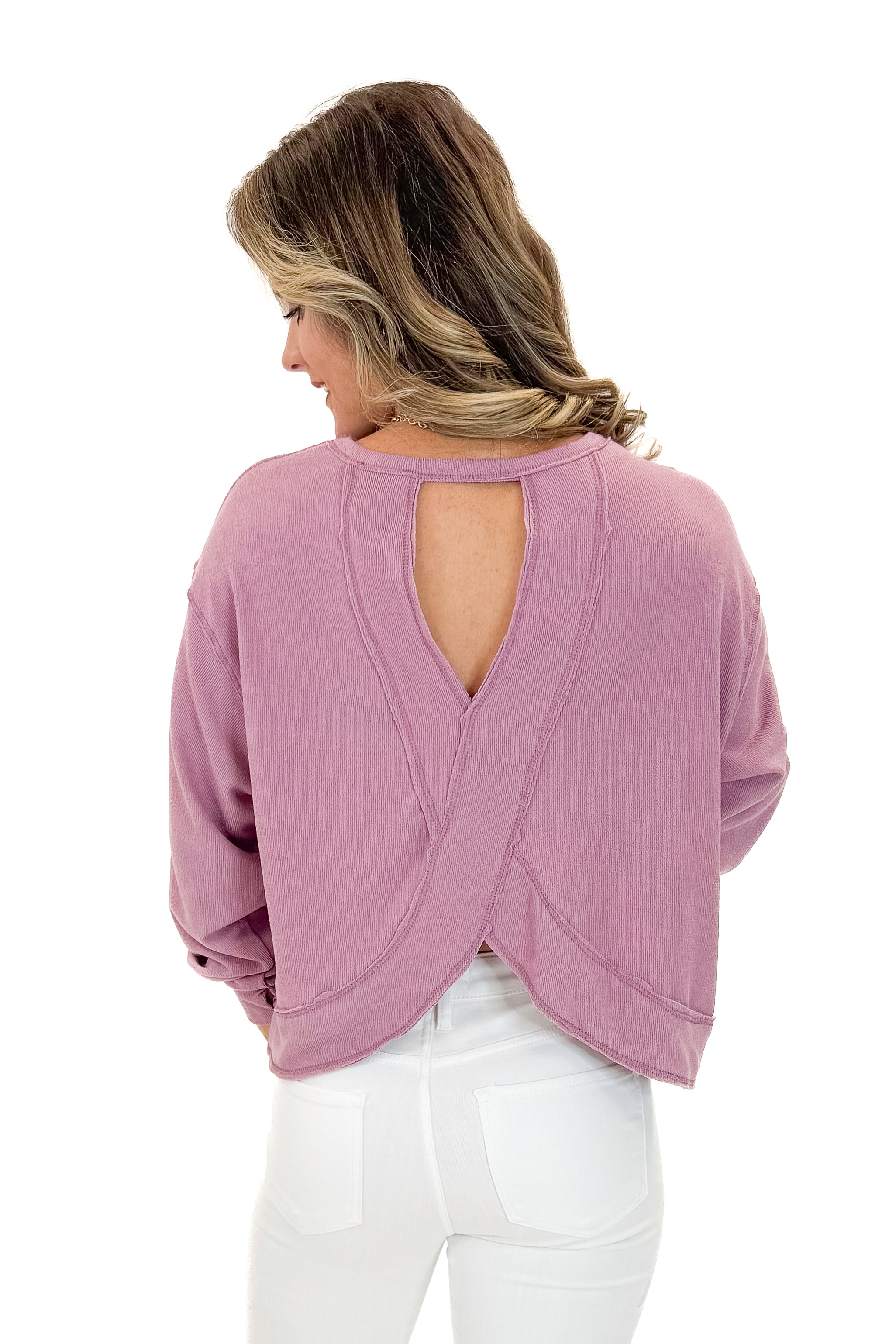 Back view of woman wearing Mauve Open Back Top with jeans against white studio background.