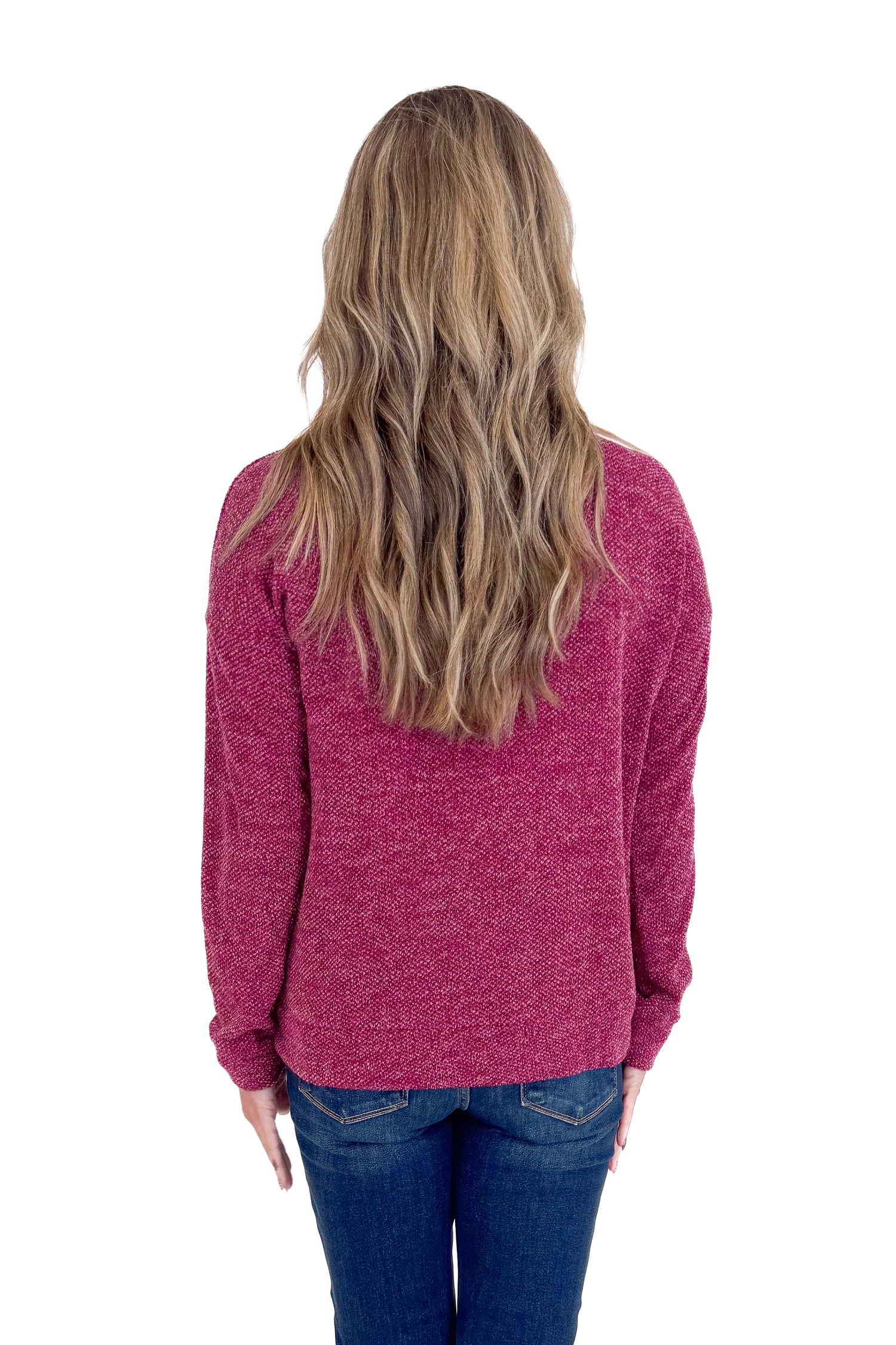 Person wearing a maroon sweater with a white background