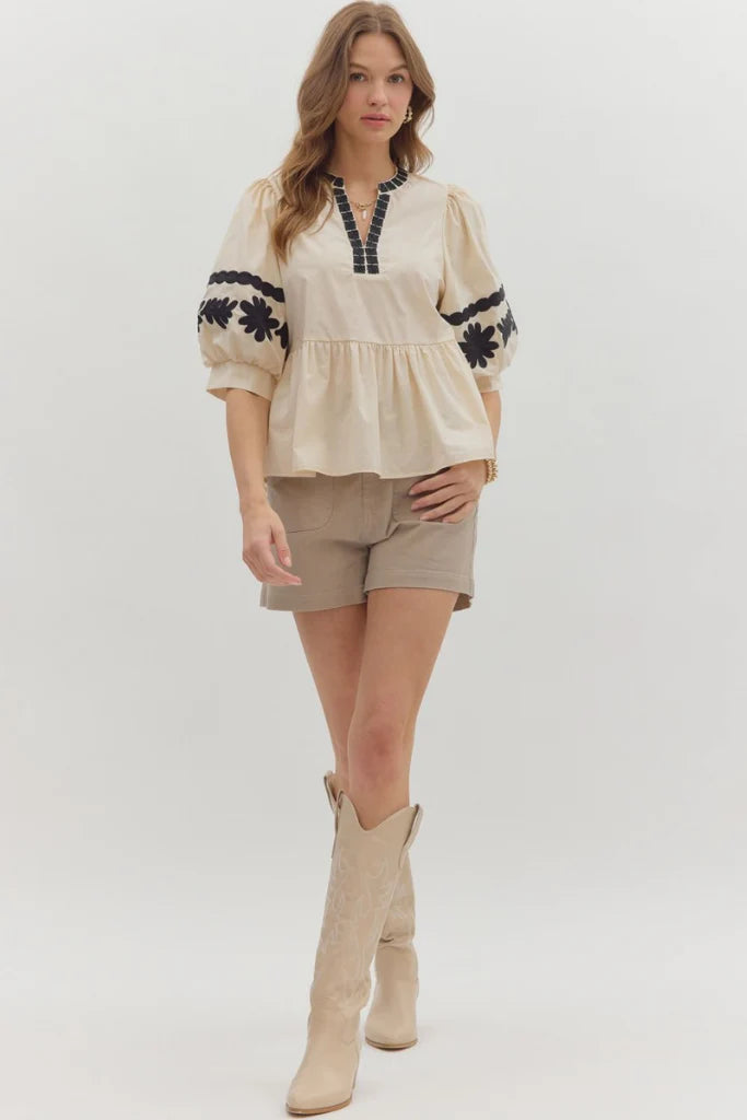 In Good Spirits Ecru With Black Embroidered Sleeve Peplum Top by Entro