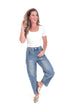 Woman wearing a white top and blue jeans on a white background