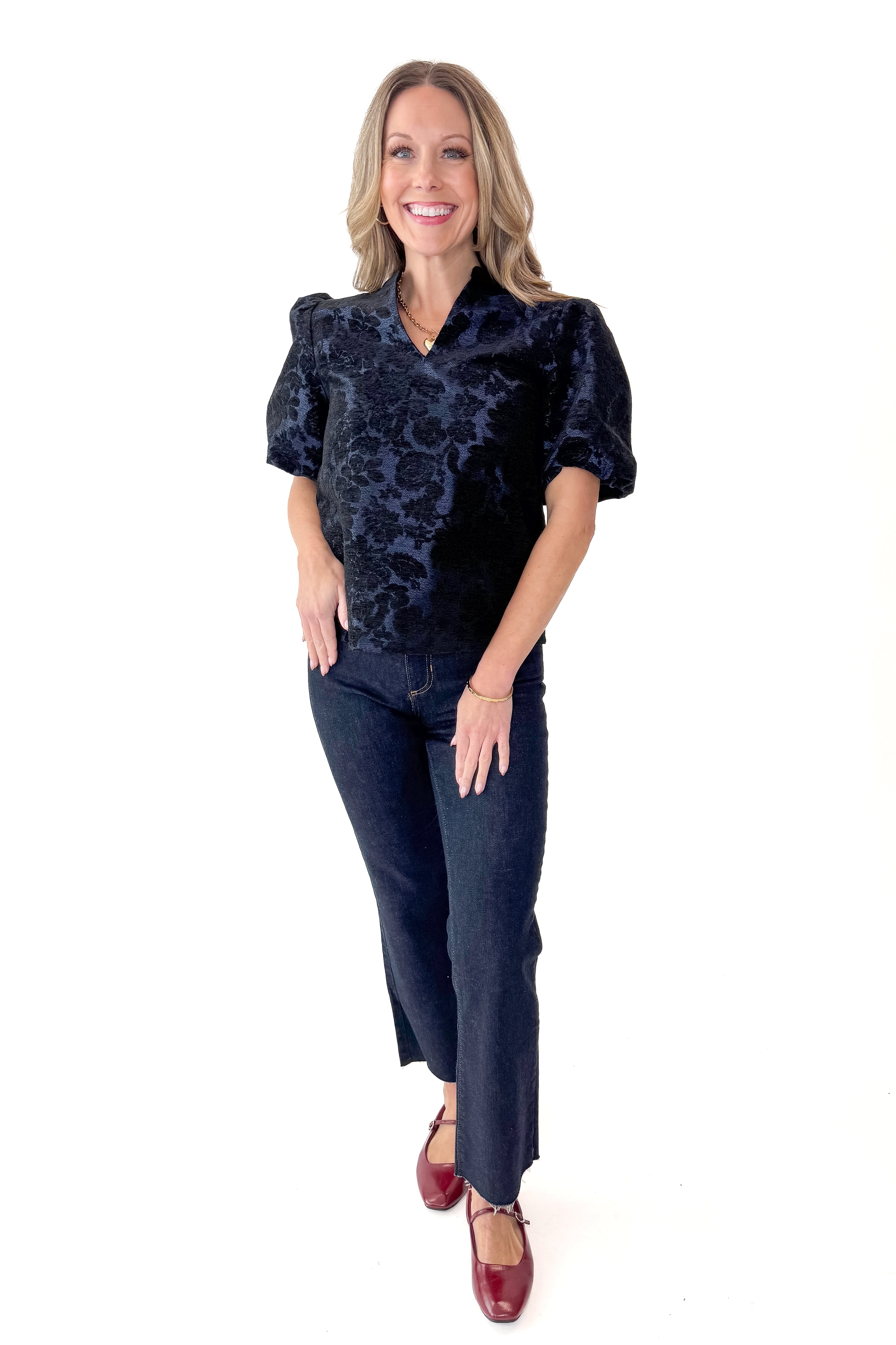 Front view of woman wearing Navy Floral Velvet Jacquard Top with jeans against white studio background.
