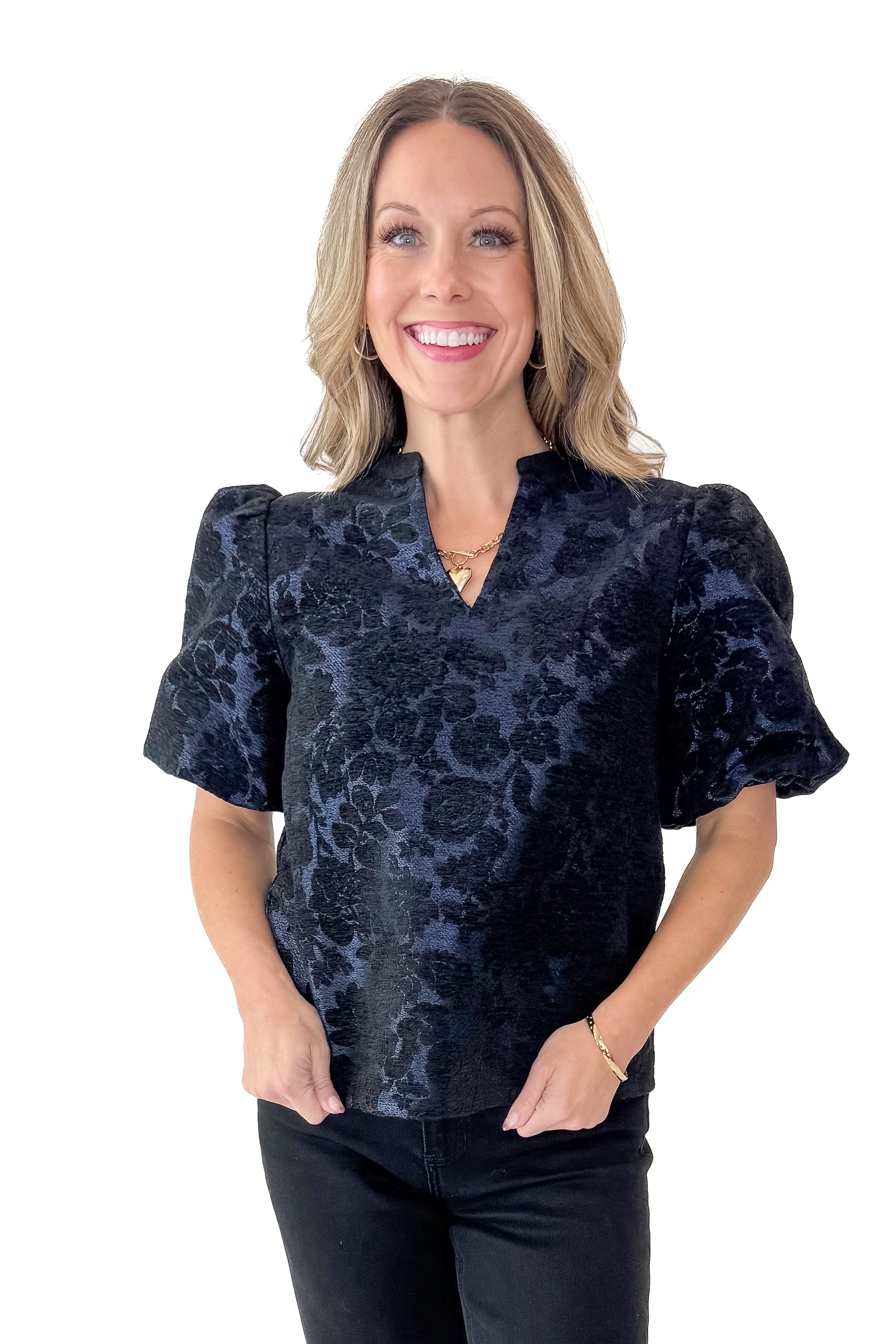 Front view of woman wearing Navy Floral Velvet Jacquard Top with jeans against white studio background.