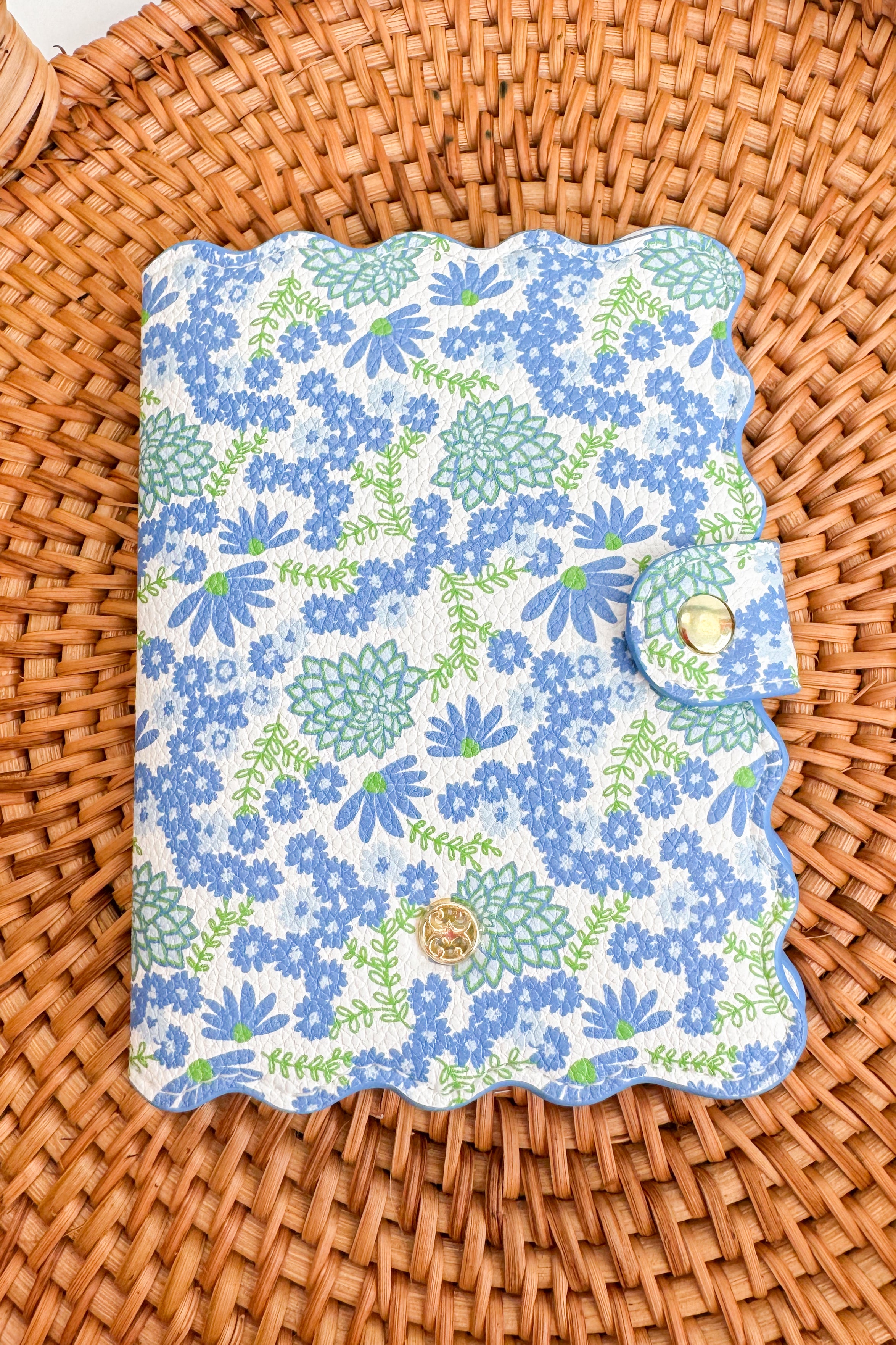 Floral-patterned passport cover on a woven surface