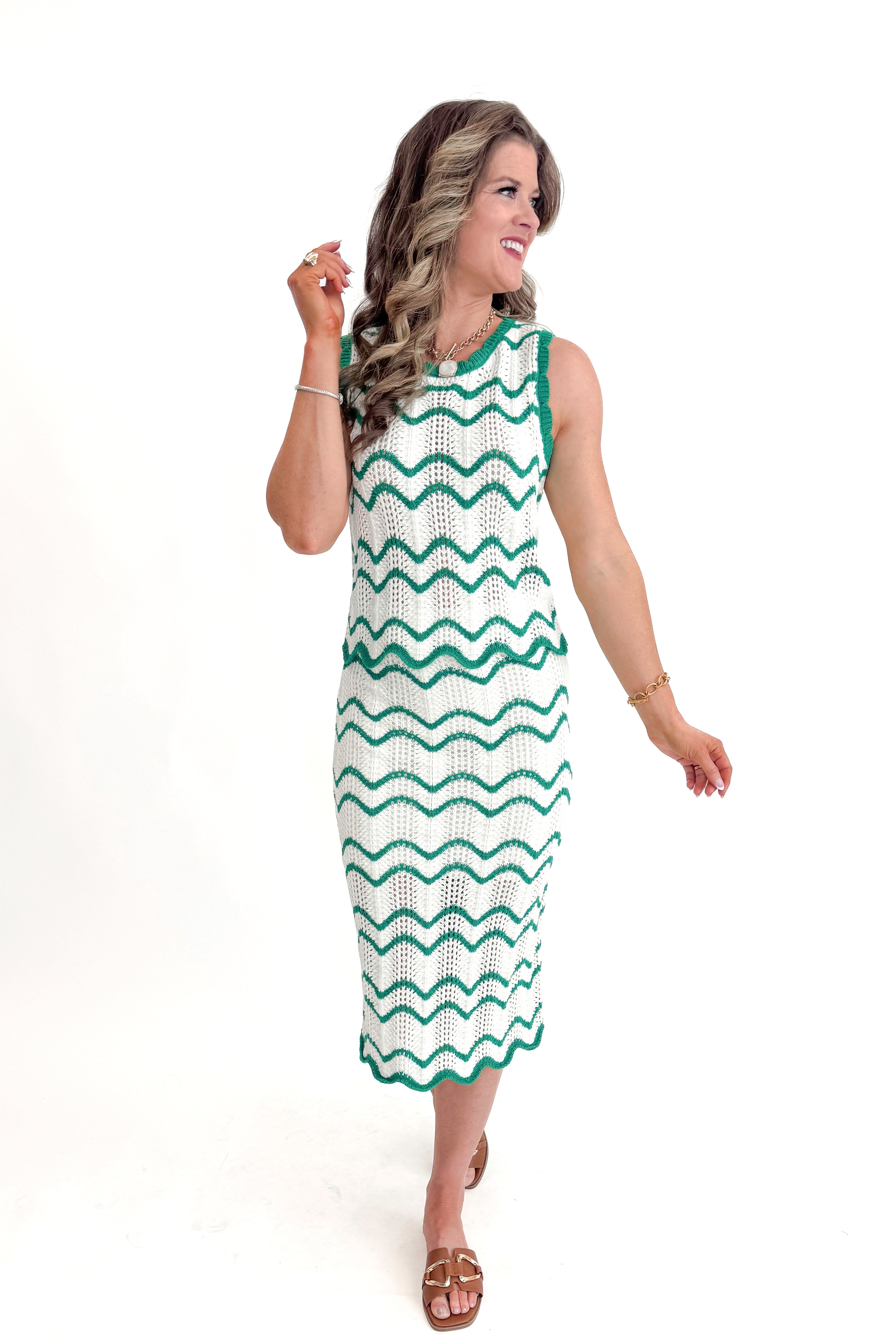 Front view of woman wearing Ivory & Green Scalloped Tank by Skies Are Blue with matching skirt against white studio background.