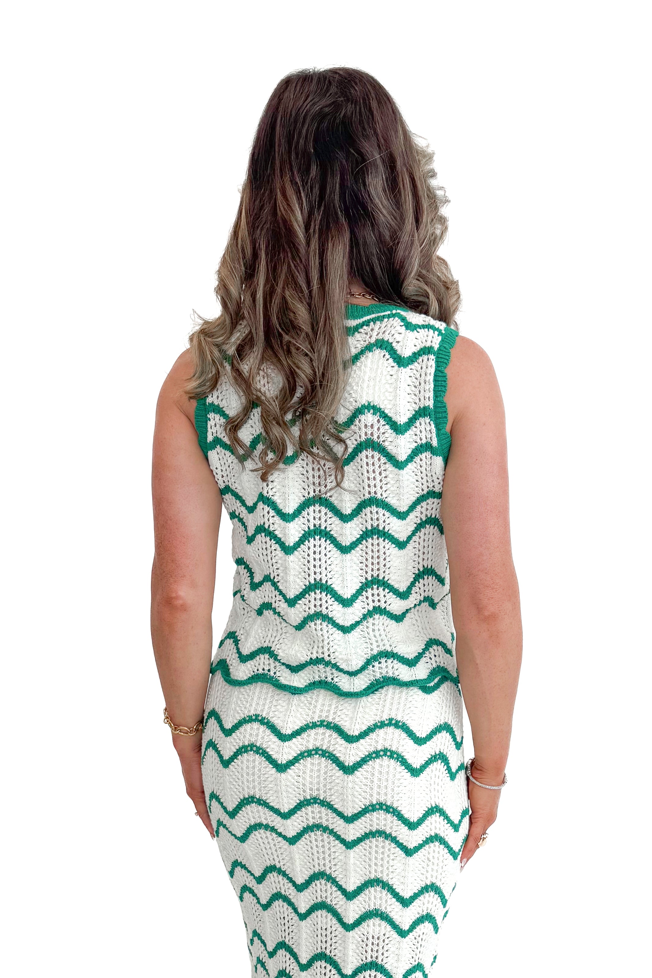 Back view of woman wearing Ivory & Green Scalloped Tank by Skies Are Blue with matching skirt against white studio background.