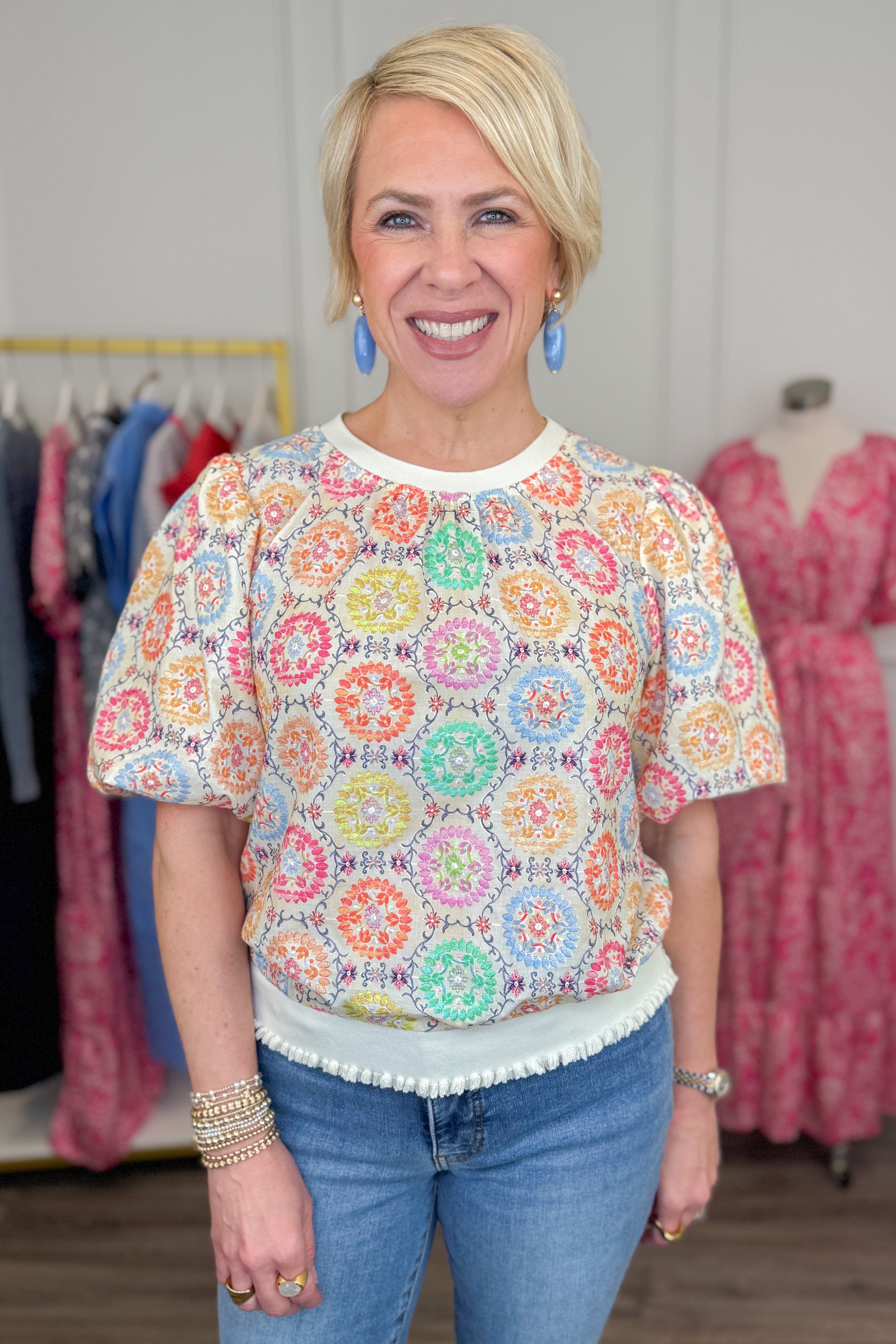 Front view of woman wearing Multi Circle & Floral Print Top with jeans and sandals.