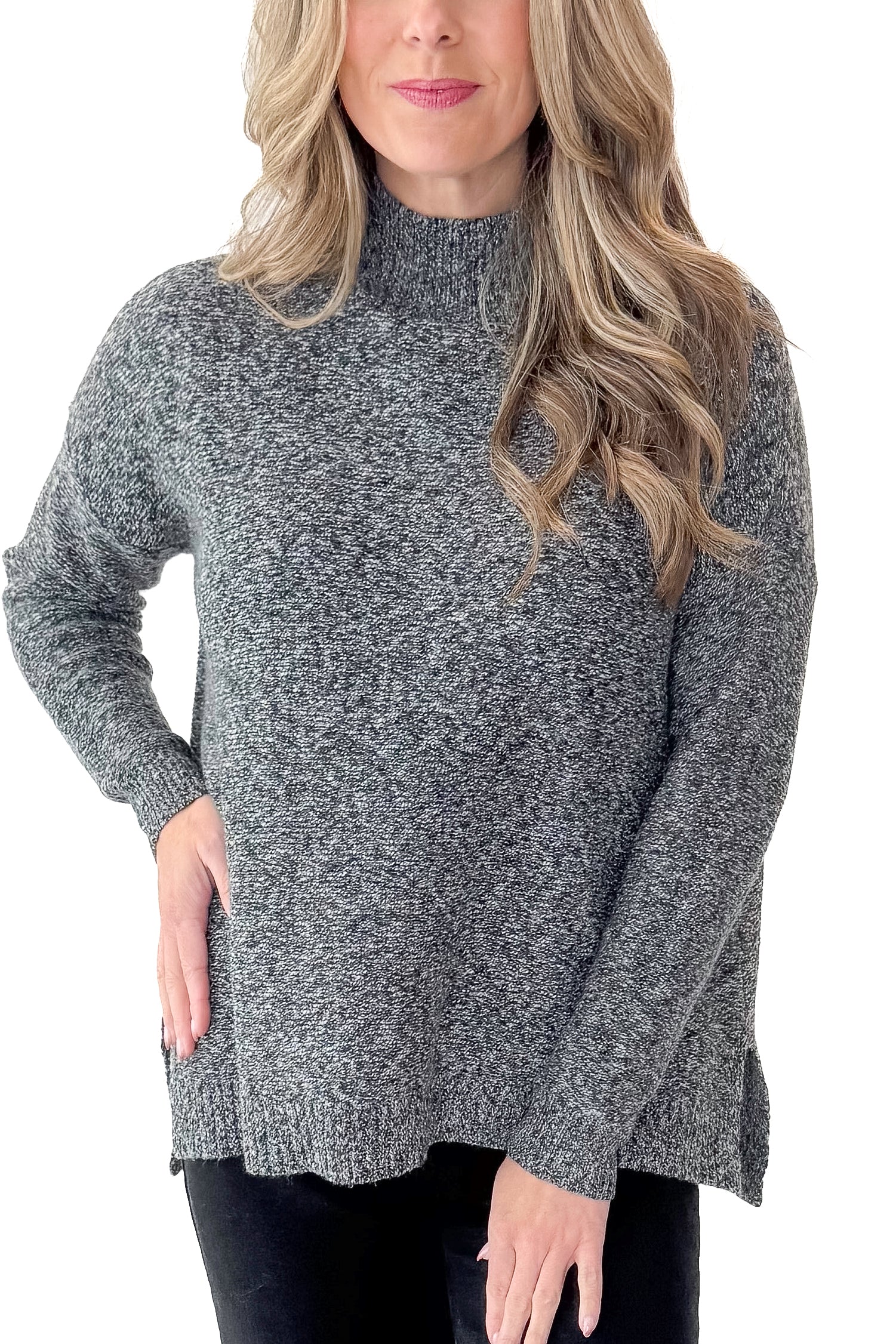 Front detail view of woman wearing Black & Cream Marled Mock Neck Sweater with jeans against white studio background.