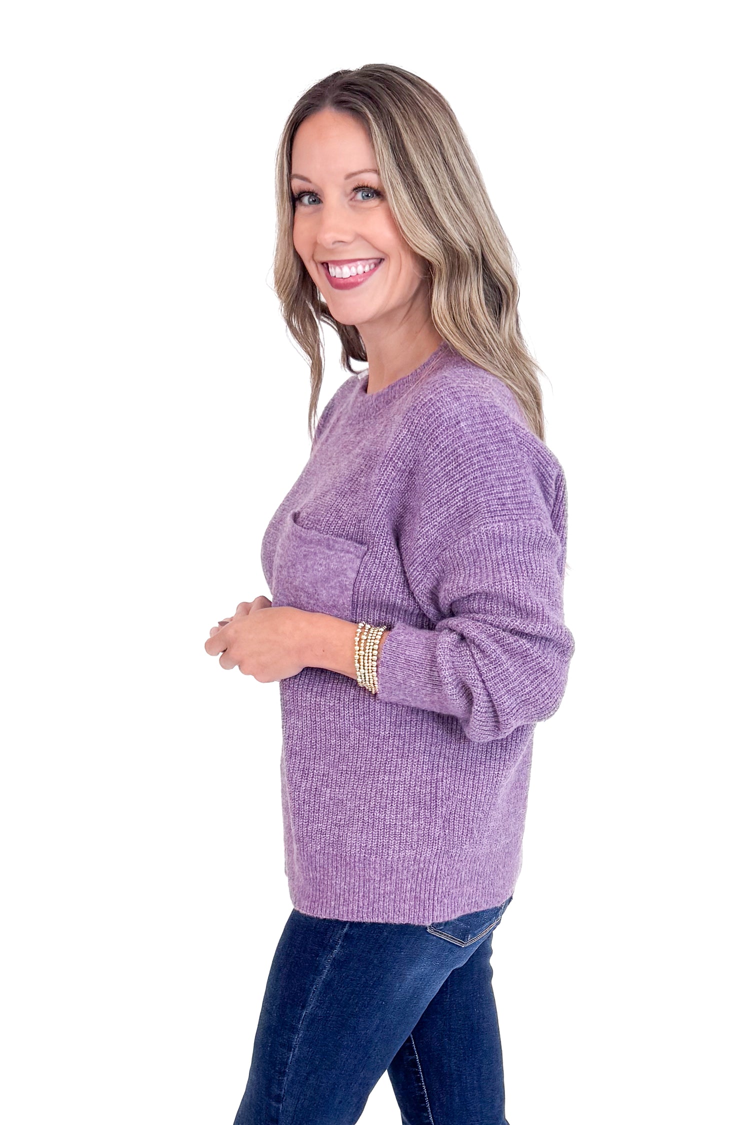Woman wearing a purple sweater on a white background