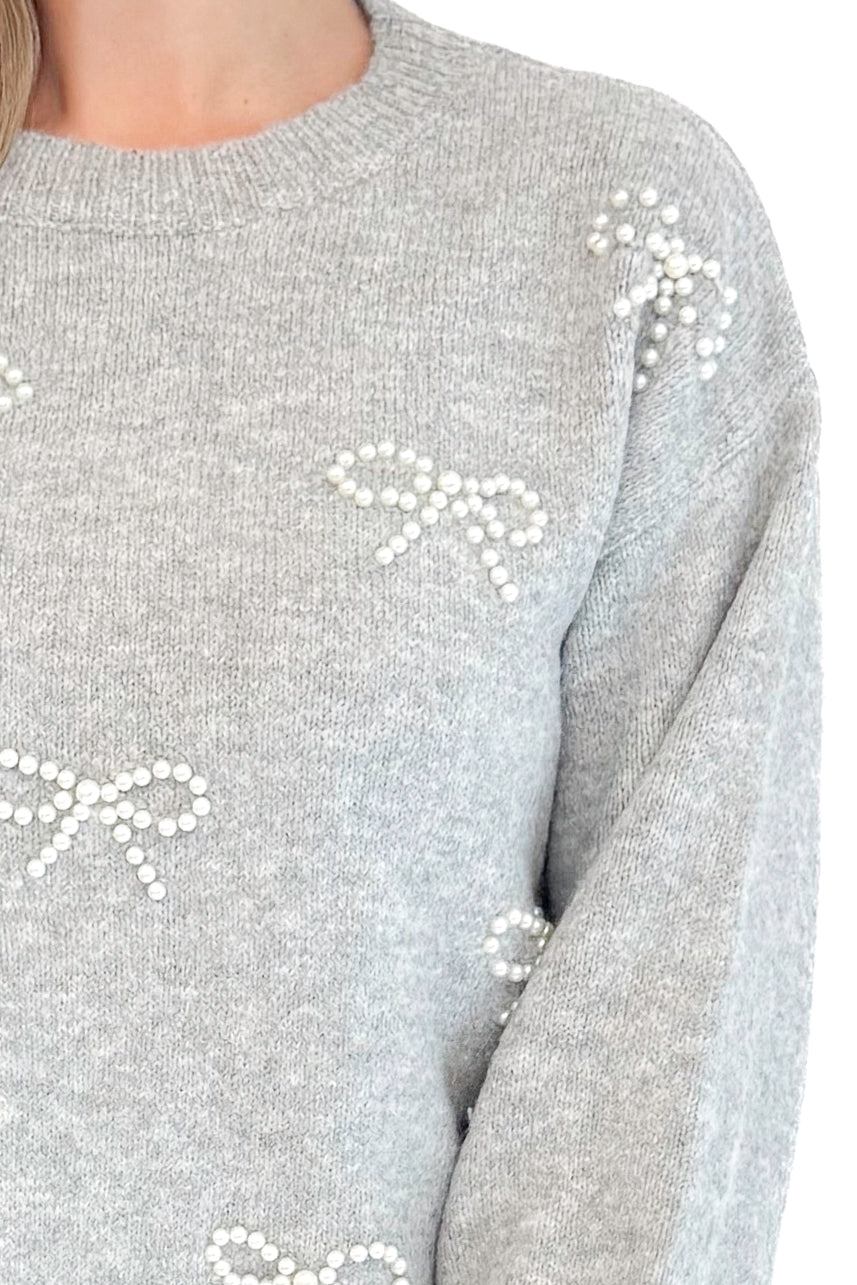 Front very detailed view of woman wearing Grey Pearl Bow Detail Sweater.