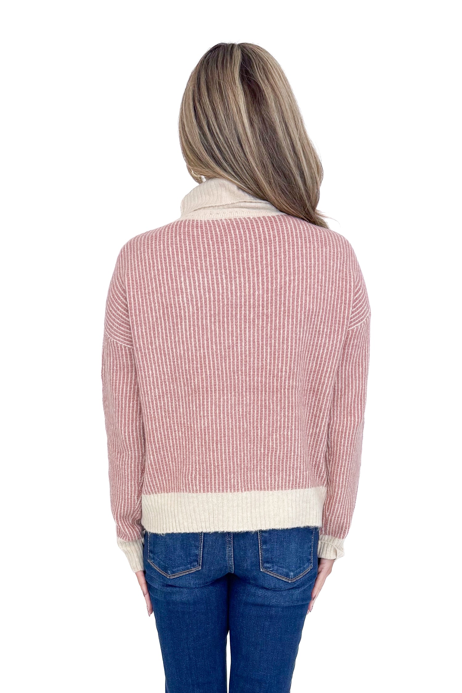 Back picture of woman wearing Mauve Striped Turtleneck Sweater and blue jeans against a white background.