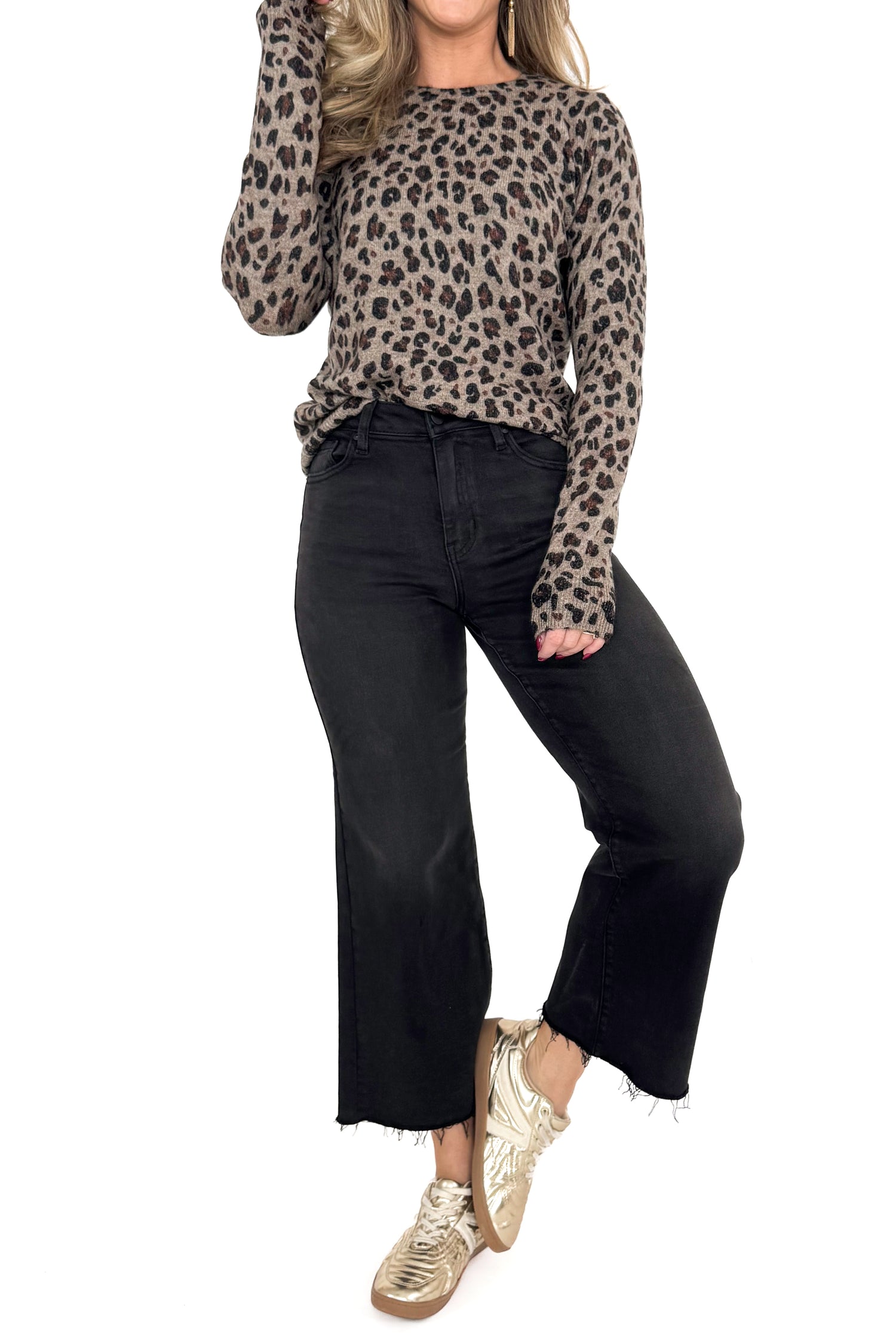 Front view of woman wearing Mocha Leopard Crewneck Sweater with jeans against white studio background.