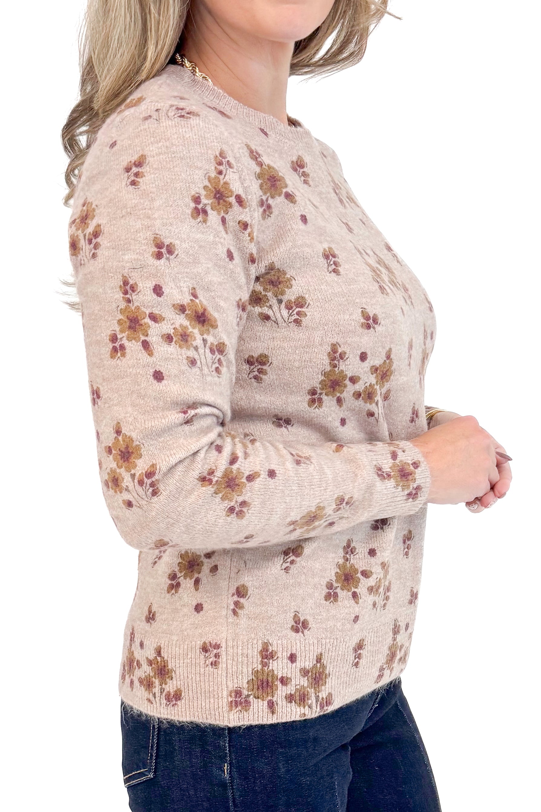Side detail view of woman wearing Blush Floral Print Sweater and jeans .