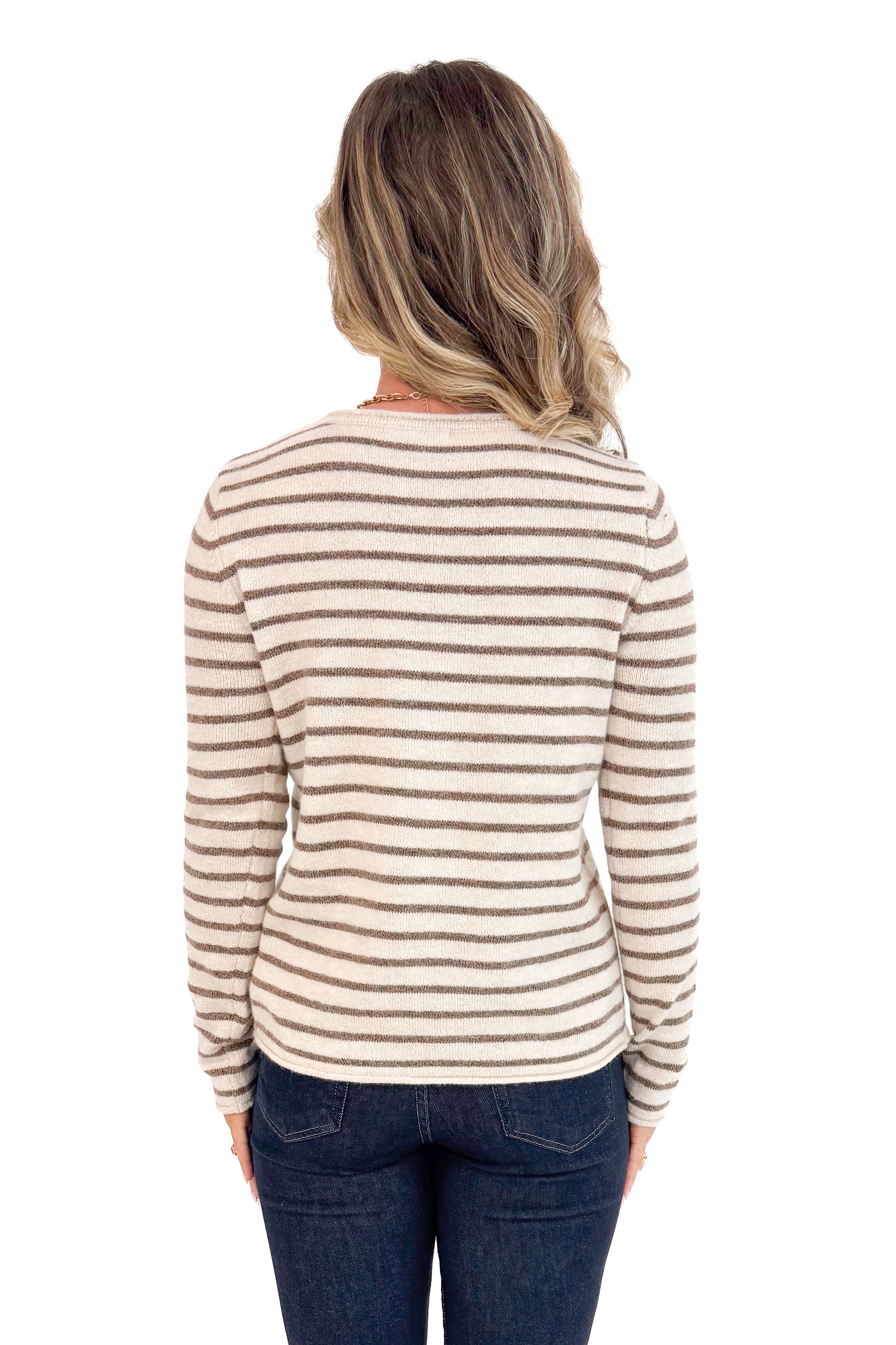 Back view of woman wearing Taupe and Brown Striped Sweater and jeans with white background.