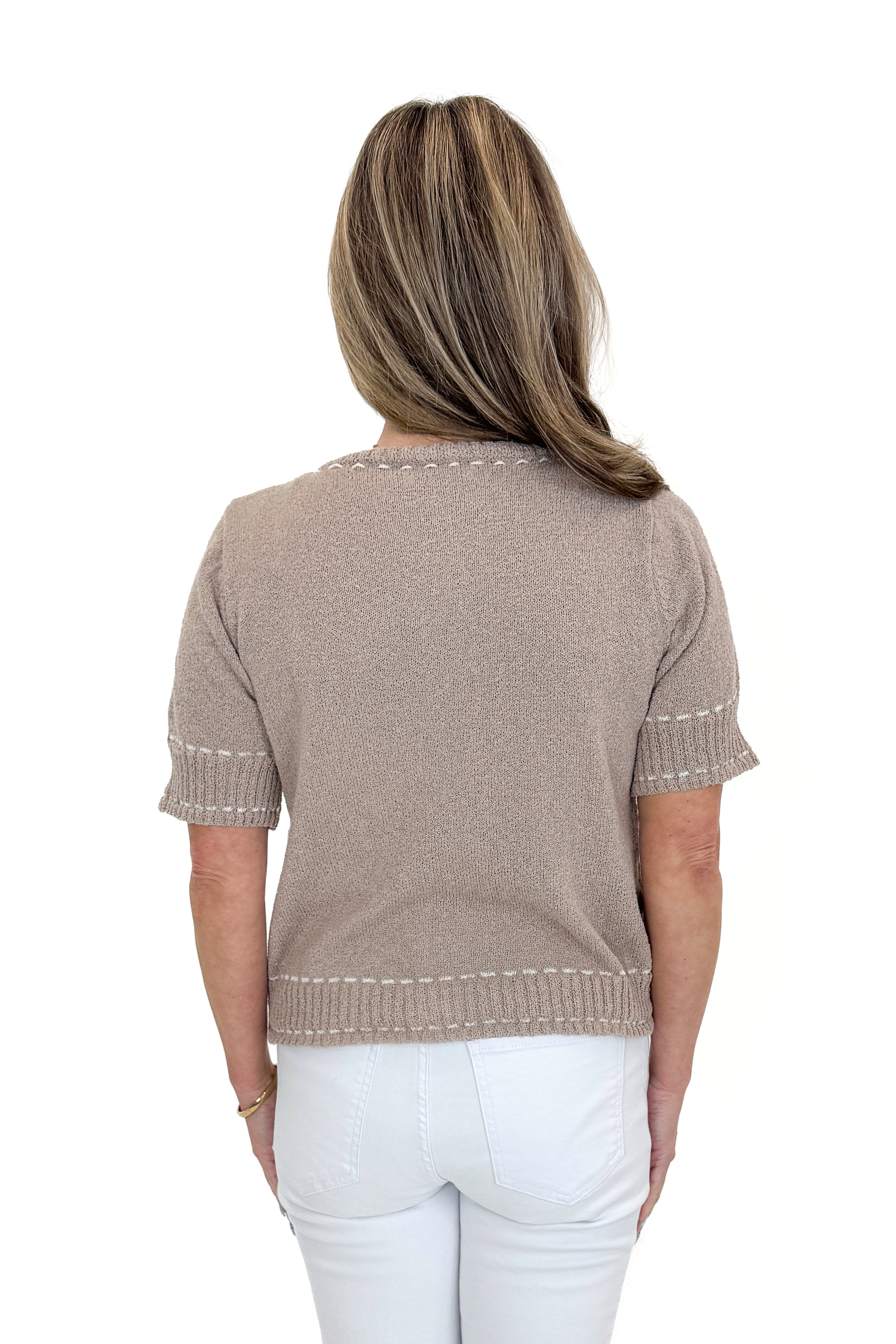 Back view of woman wearing Taupe Faux Stitch Detail Short Sleeve Sweater with jeans against white studio background.