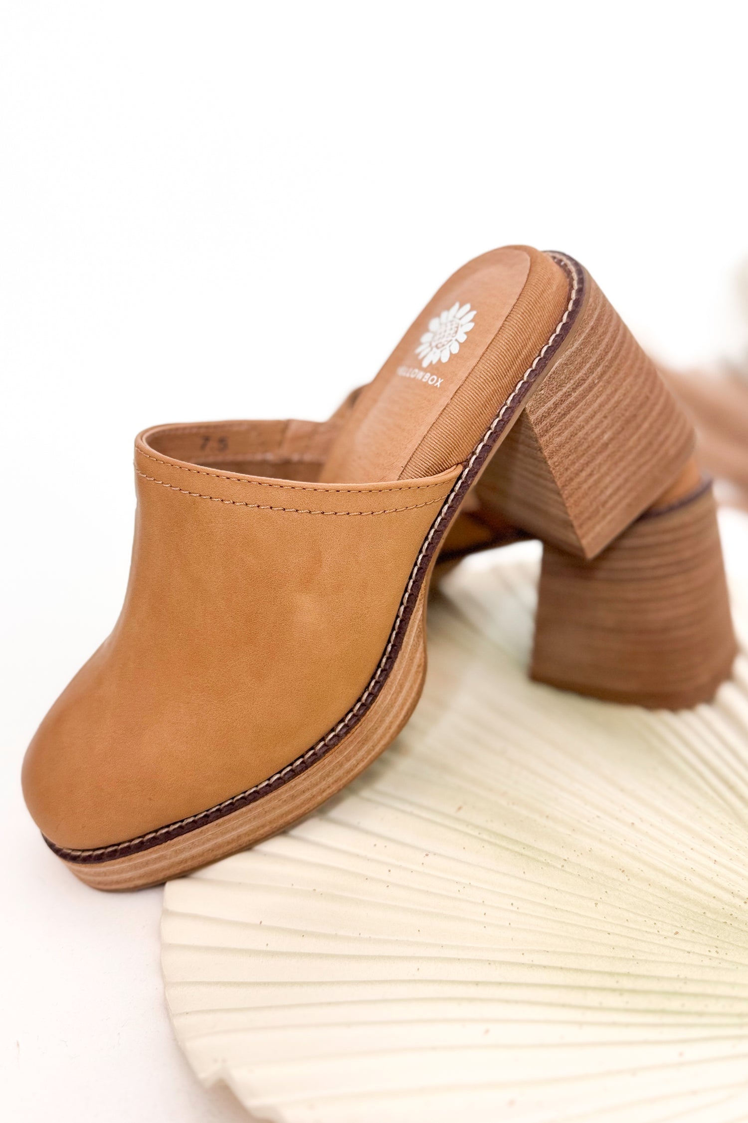 Tan clog shoe on a white background