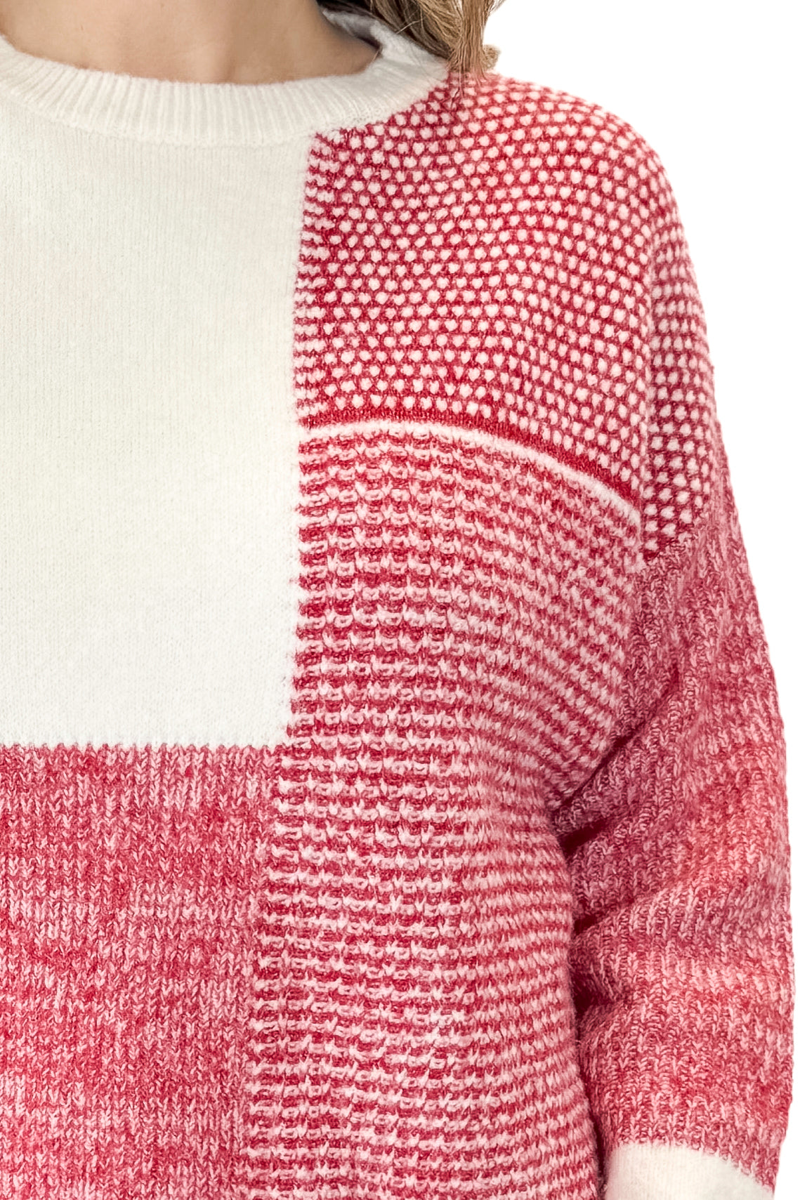 Front detail view of woman wearing Cream & Red Color Block Sweater with jeans against white studio background.