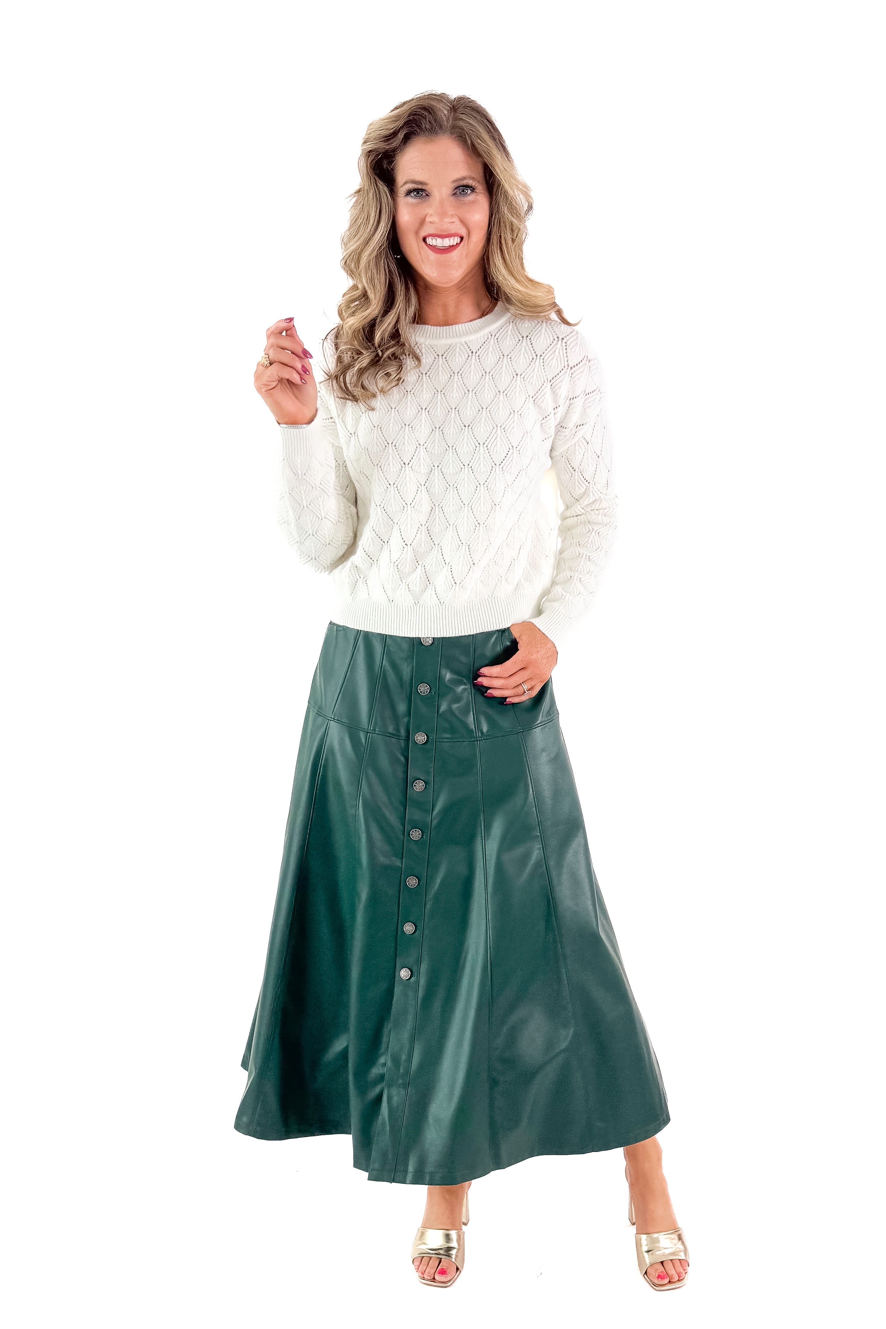 Front view of woman wearing Ivory Textured Knit Sweater with skirt against white studio background.
