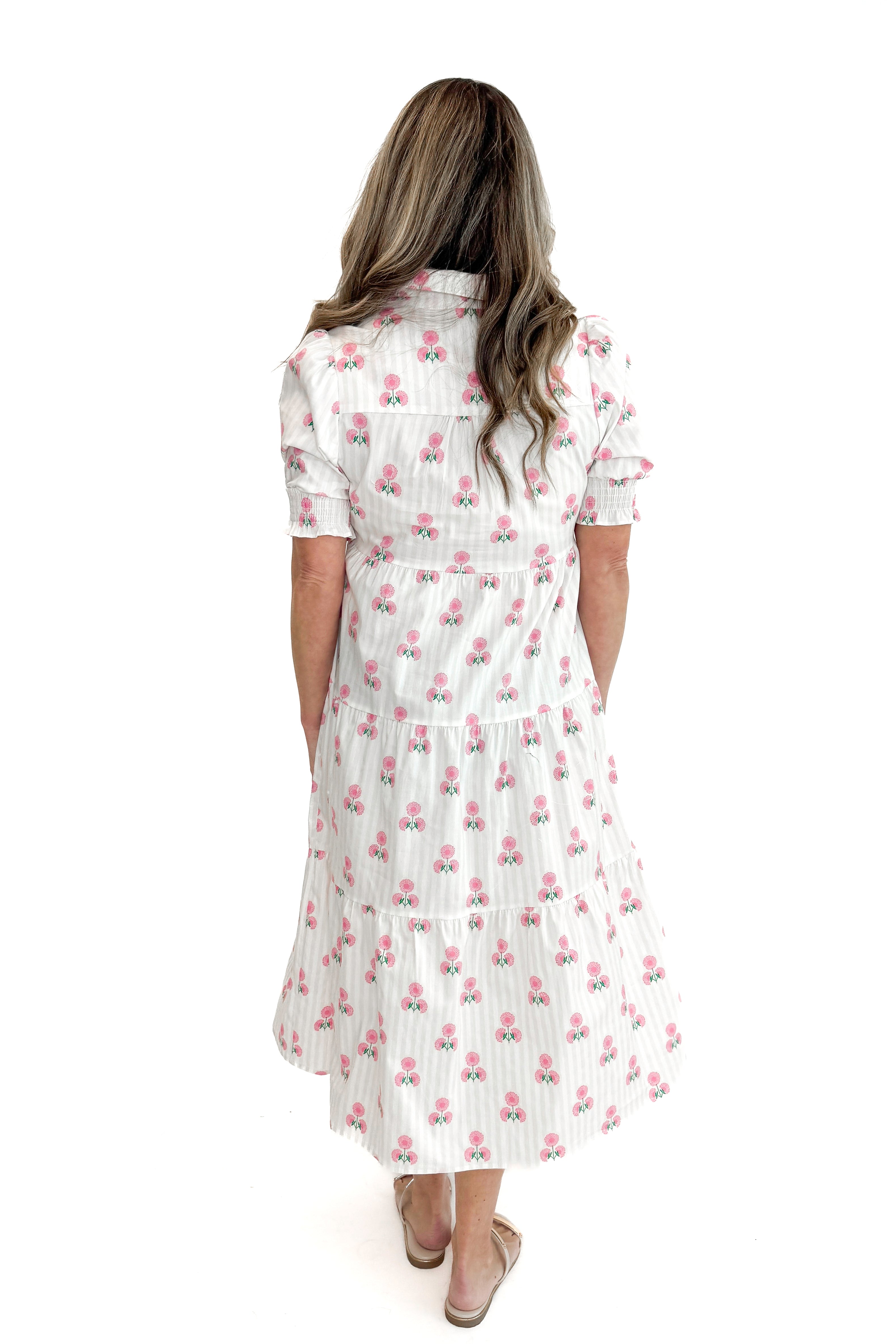 Back view of woman wearing Neutral Stripe & Pink Floral Molly Dress by Mary Square with sandals against white studio background.
