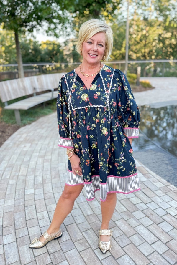 Woman wearing a floral dress with a plain background