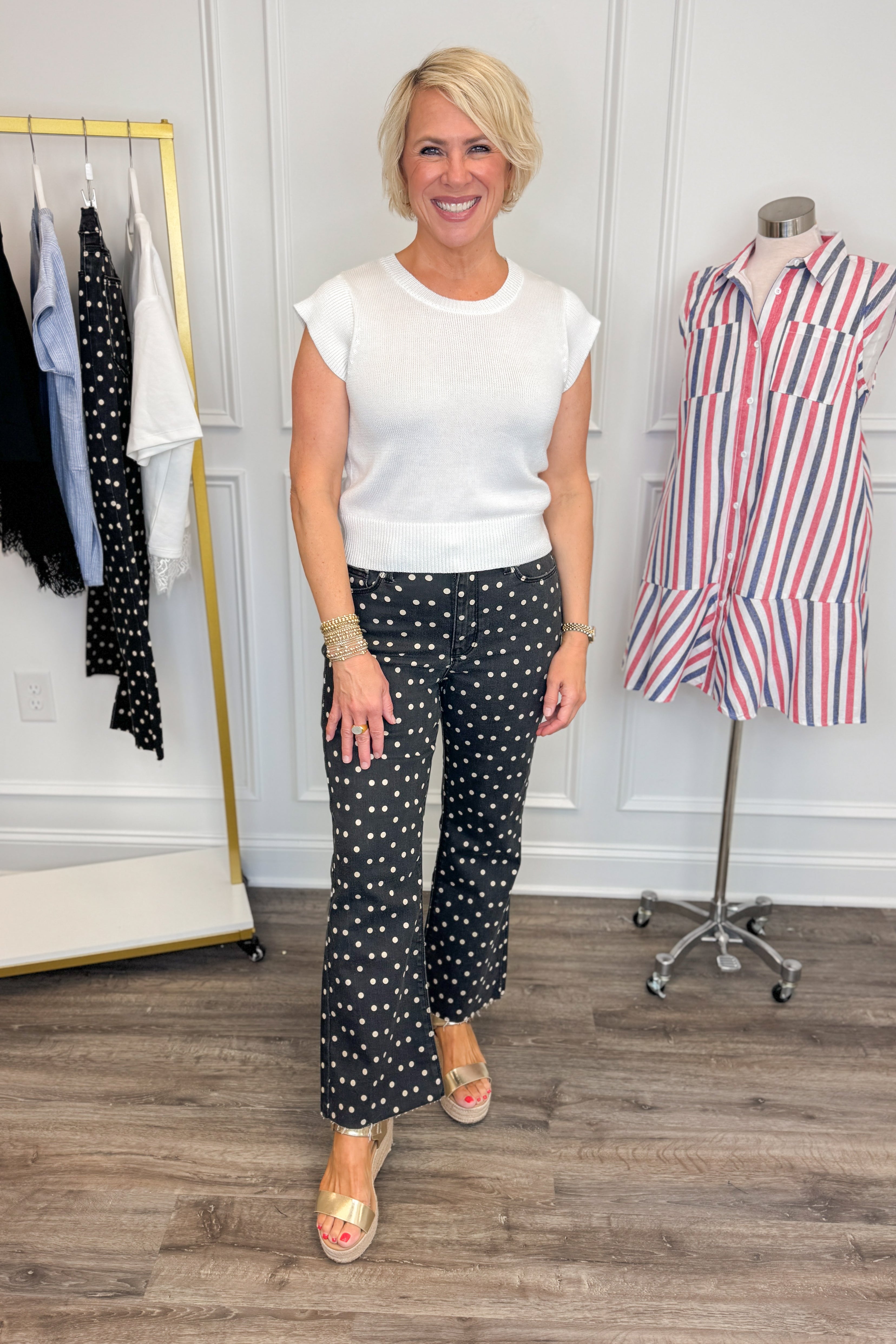 Front view of woman wearing Swagger Boutiqueās Black & White Polka Dot Crop Flare Jeans by Just Black Denim with top against white studio background.