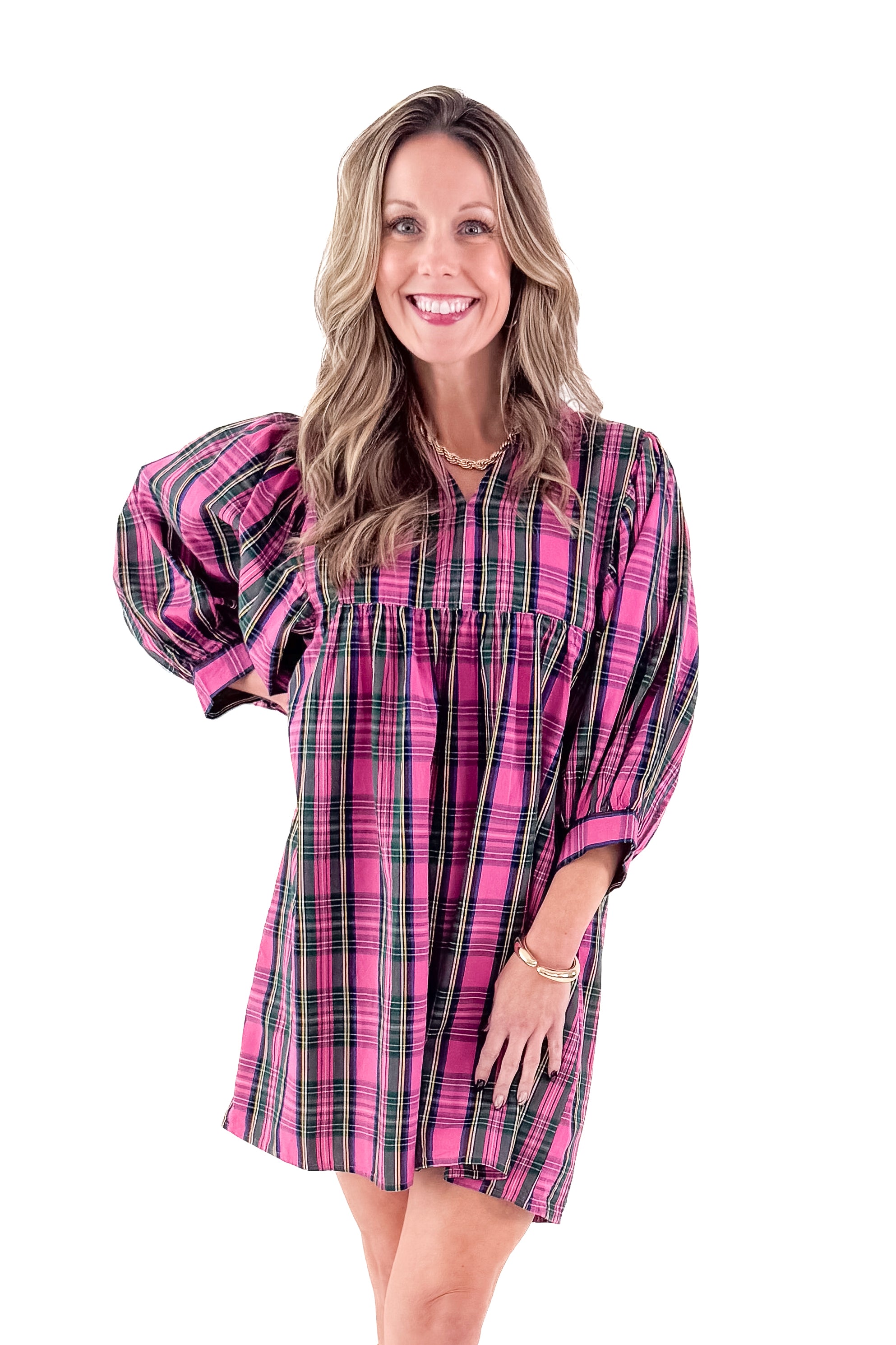 Front view of woman wearing Shipley pink plaid dress against white studio background.