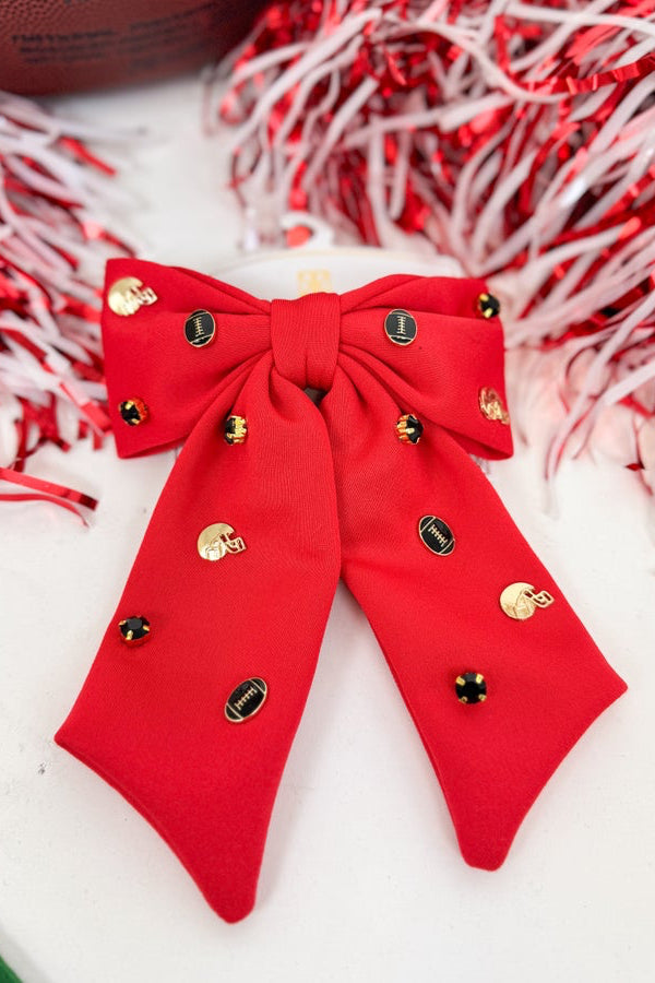 Red bow with gold and black buttons on a white background