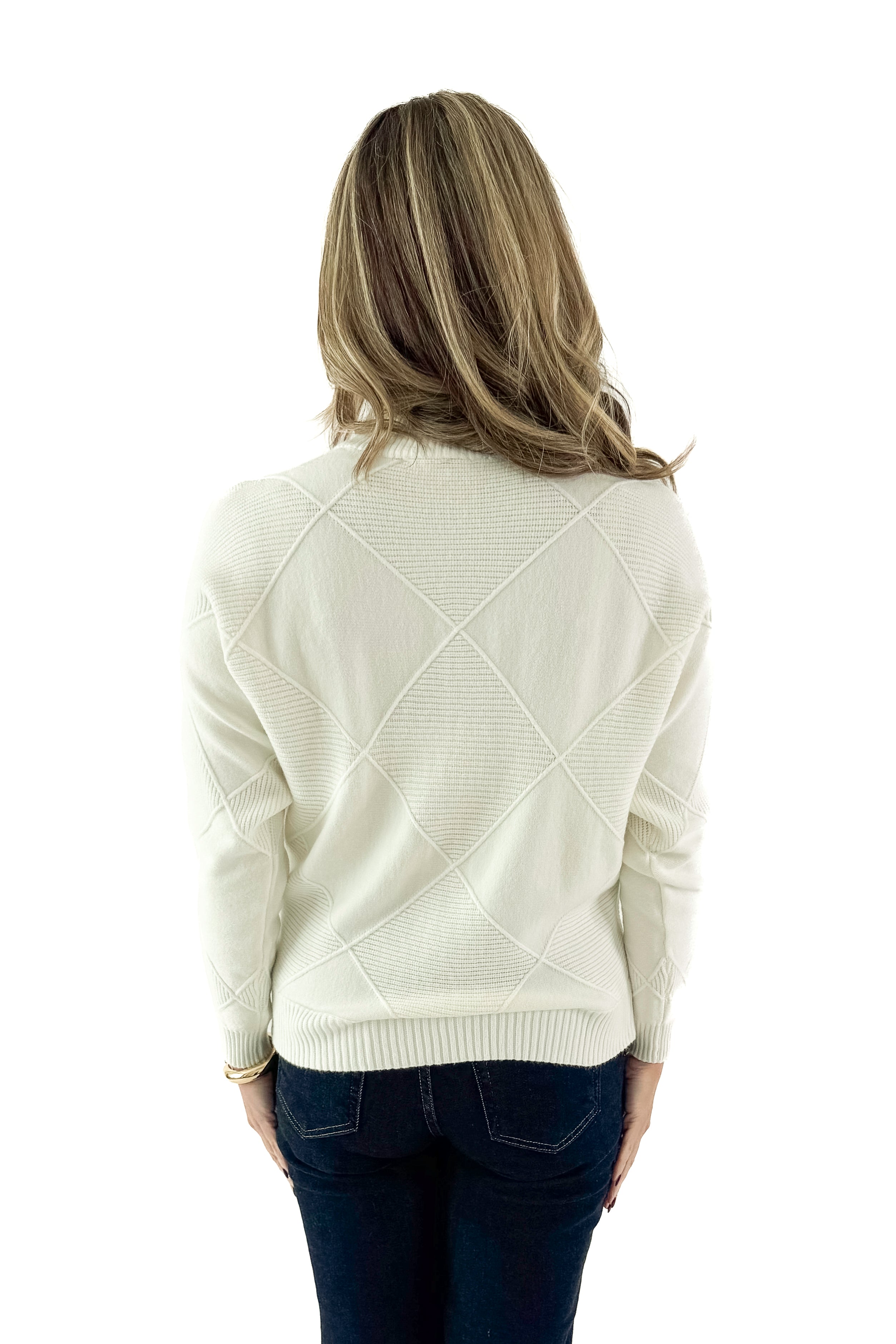Back view of woman wearing Cream Diamond Mock Neck Sweater with jeans against white studio background