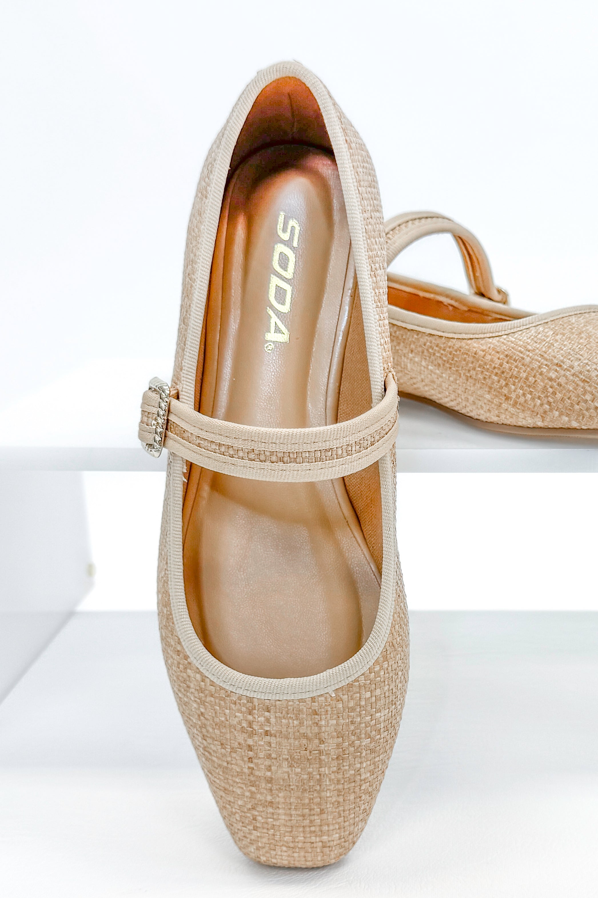 Adora- Natural Raffia Flats against white studio background.