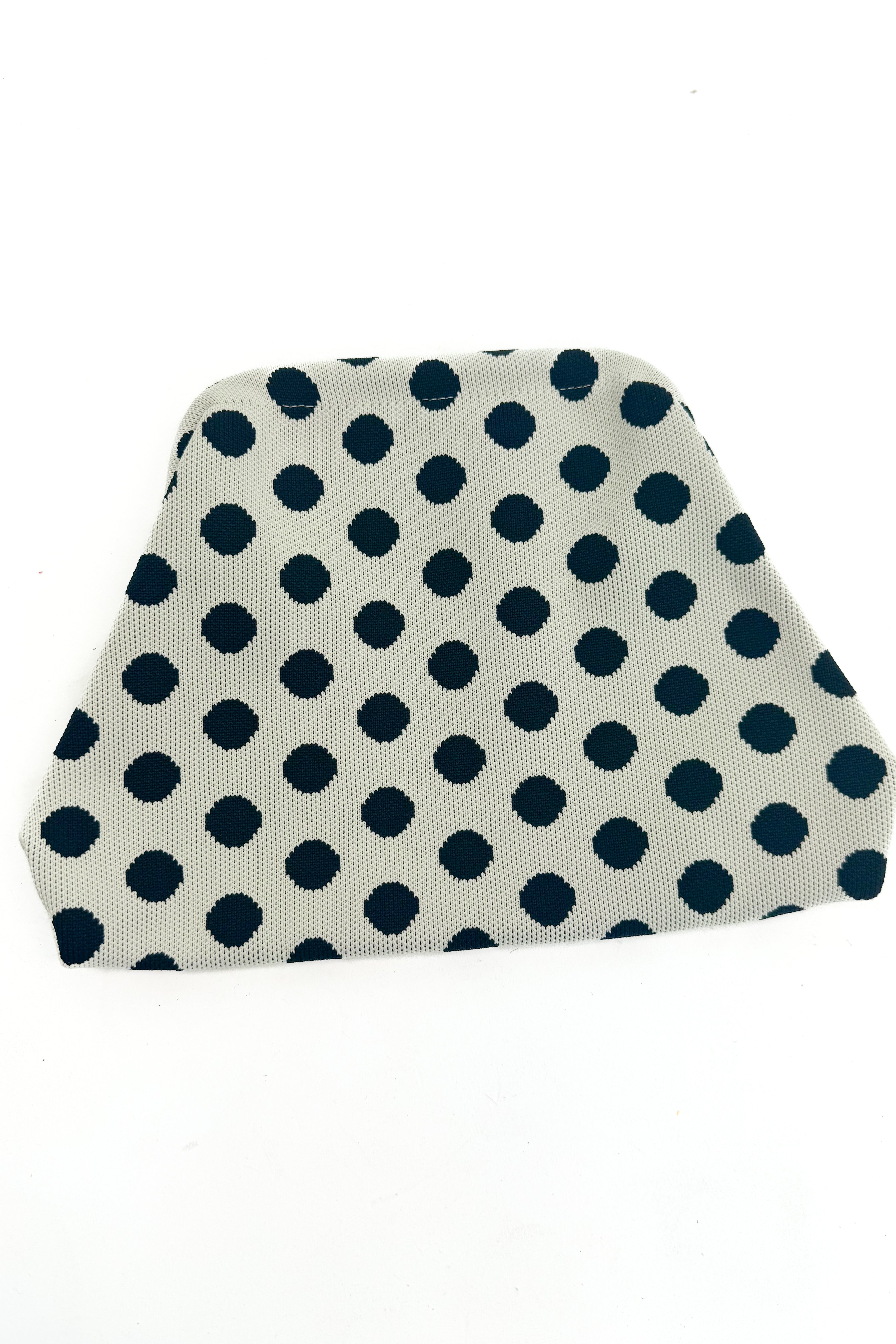 Beige fabric pouch black polka dots on a white background