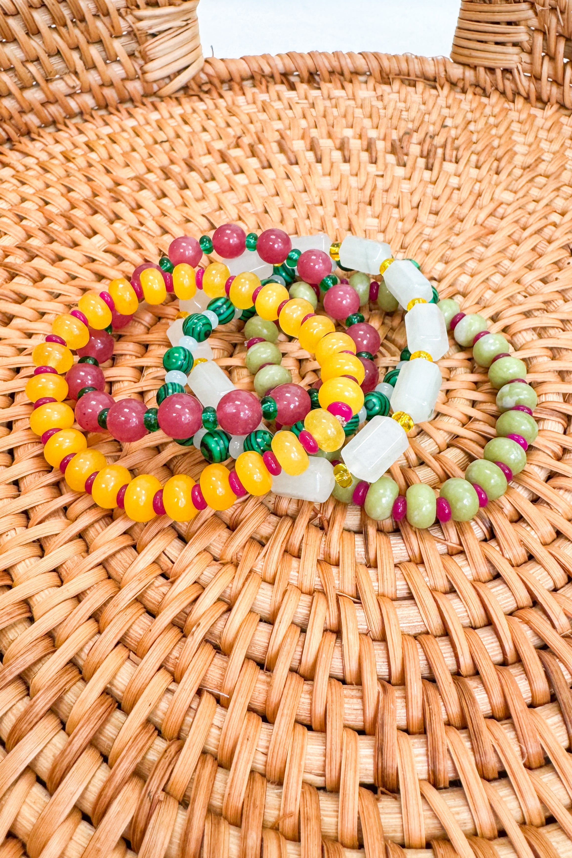 Colorful beaded bracelets on a woven surface