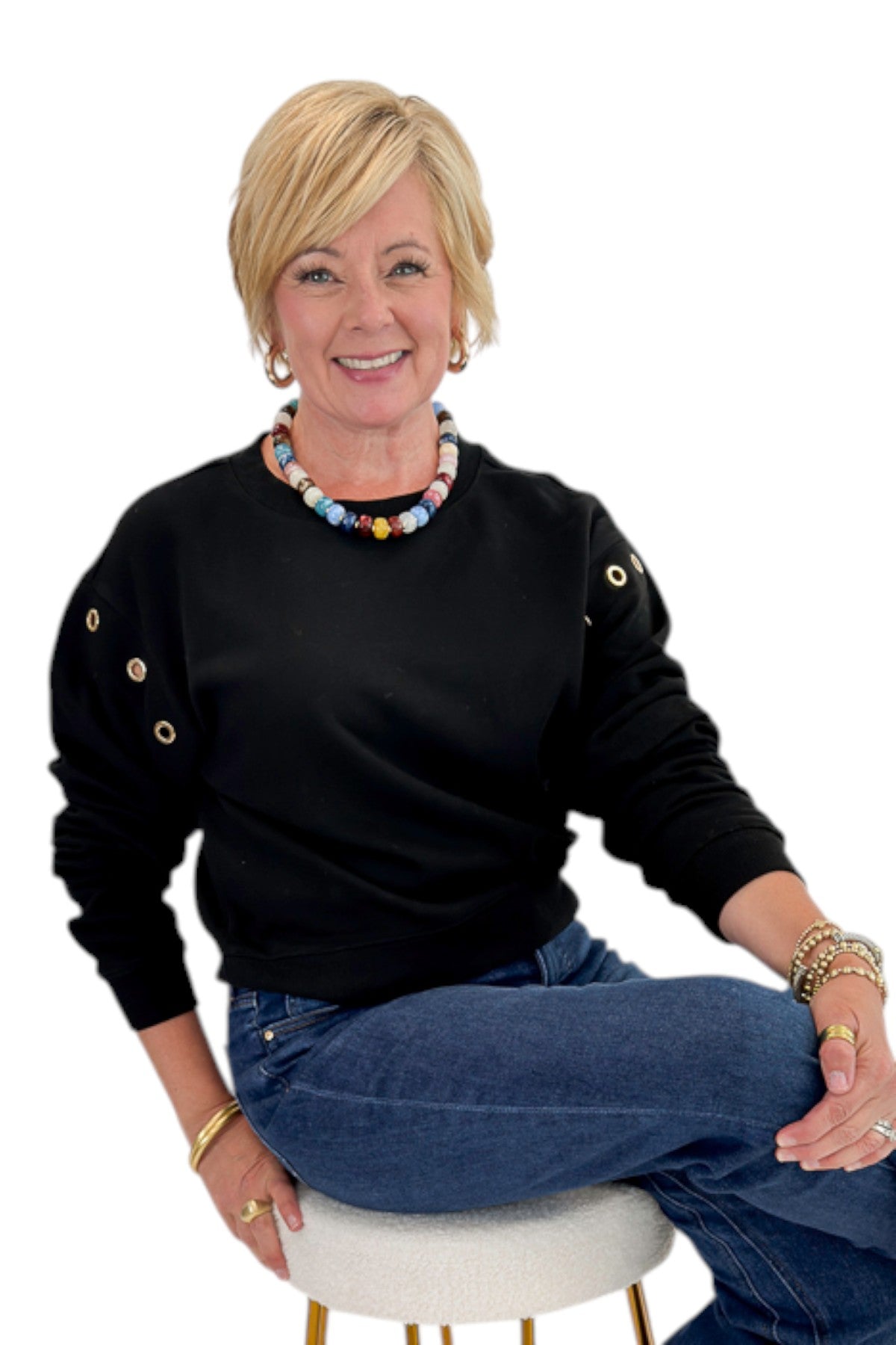 Front view of woman wearing Swagger Boutiqueās Black Axel Grommet Sweatshirt by Z Supply with jeans against white studio background.