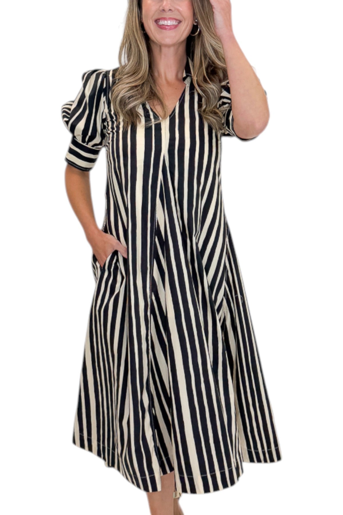 Front detail view of woman wearing Swagger Boutiqueās Black & Cream Striped Midi Dress with sandals against white studio background.