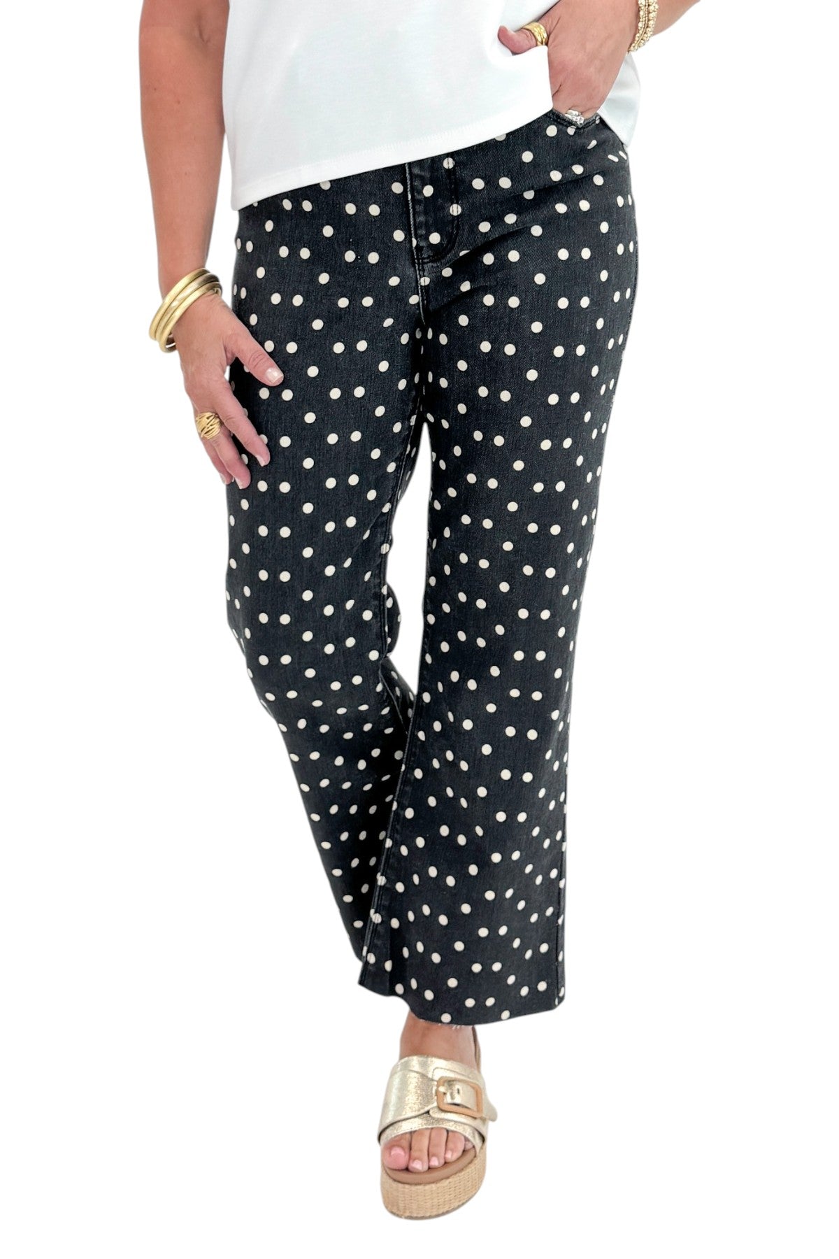 Front view of woman wearing Swagger Boutiqueās Black & White Polka Dot Crop Flare Jeans by Just Black Denim with top against white studio background.
