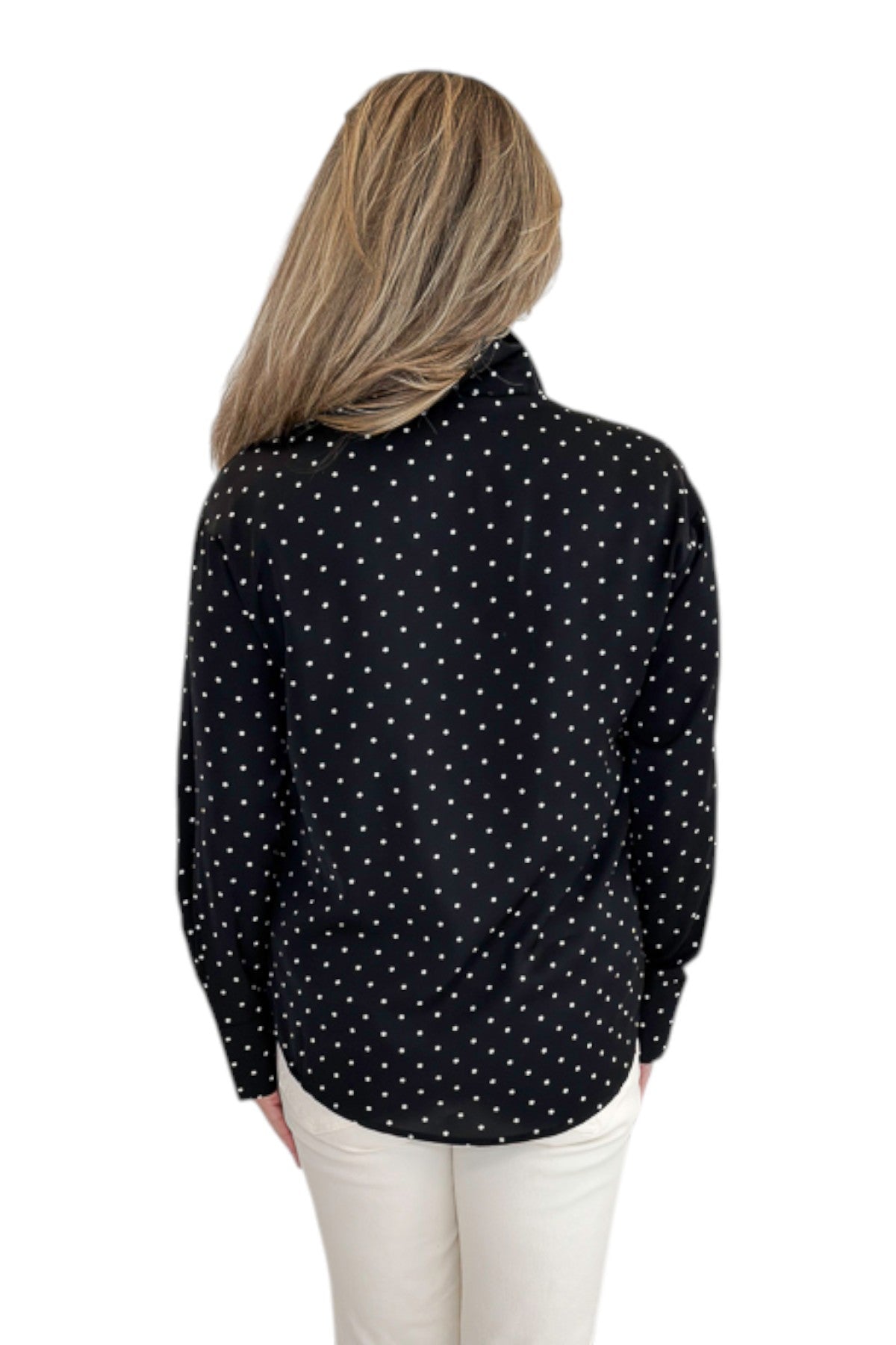 Back view of woman wearing Swagger Boutique’s Black & White Polka Dot Satin Button Up Top with jeans against white studio background.