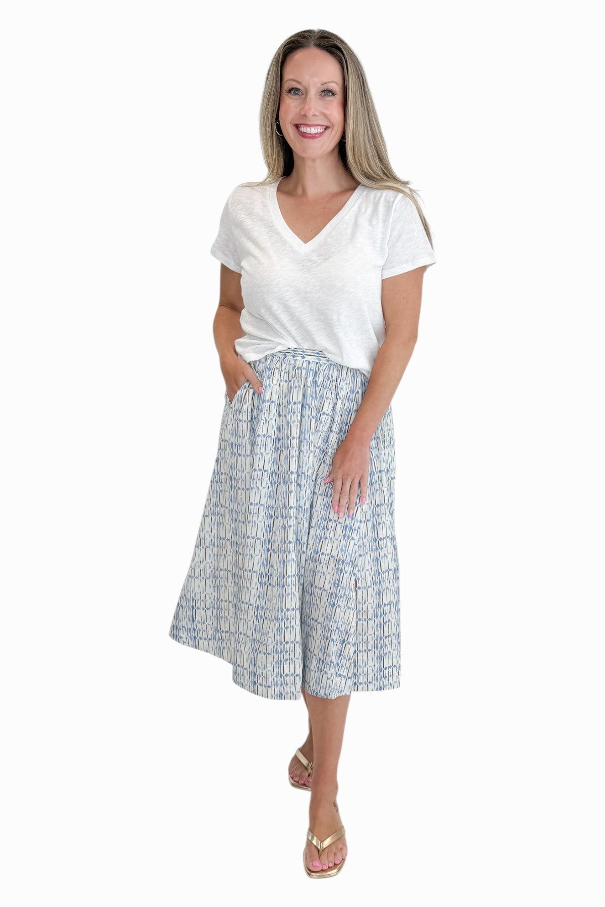 Front view of woman wearing Swagger Boutiqueās Blue & Brown Abstract Print skirt against white studio background.