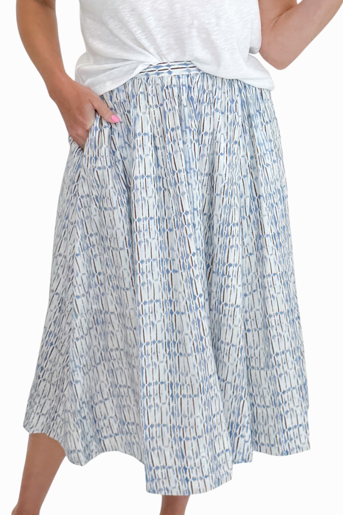 Front view of woman wearing Swagger Boutiqueās Blue & Brown Abstract Print skirt against white studio background.