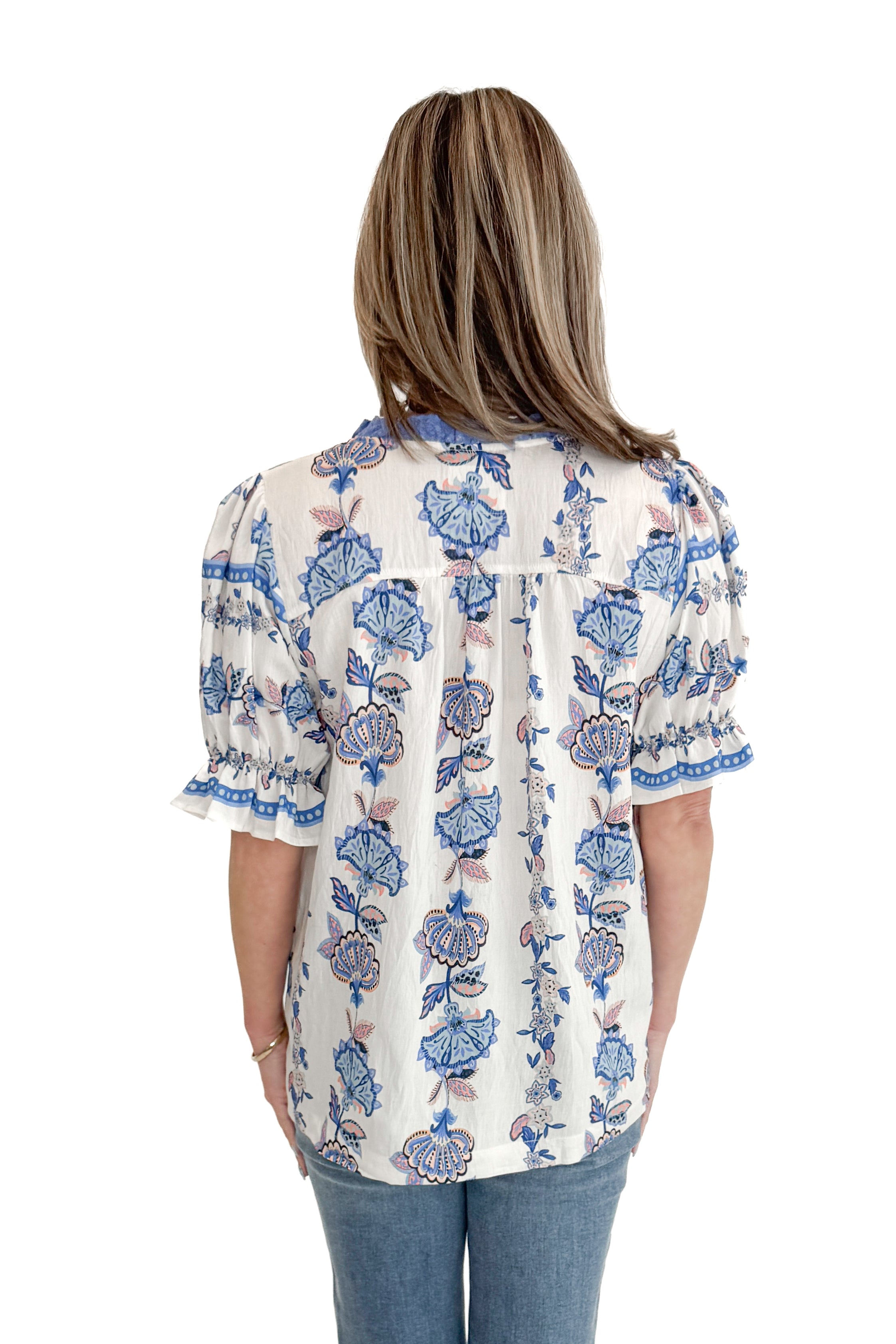 Back view of woman wearing Blue & Multi Printed Lace Detail Top with jeans against white studio background.
