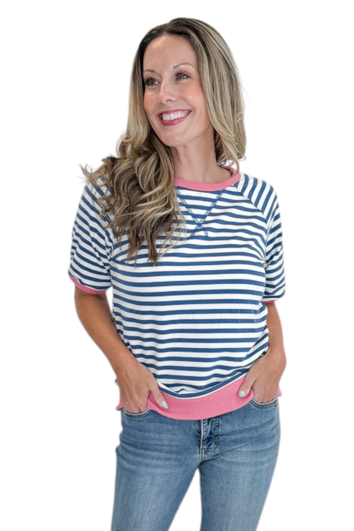 Front view of woman wearing Swagger Boutiqueās Blue & Pink Striped Short Sleeve Sweatshirt with jeans against white studio background.