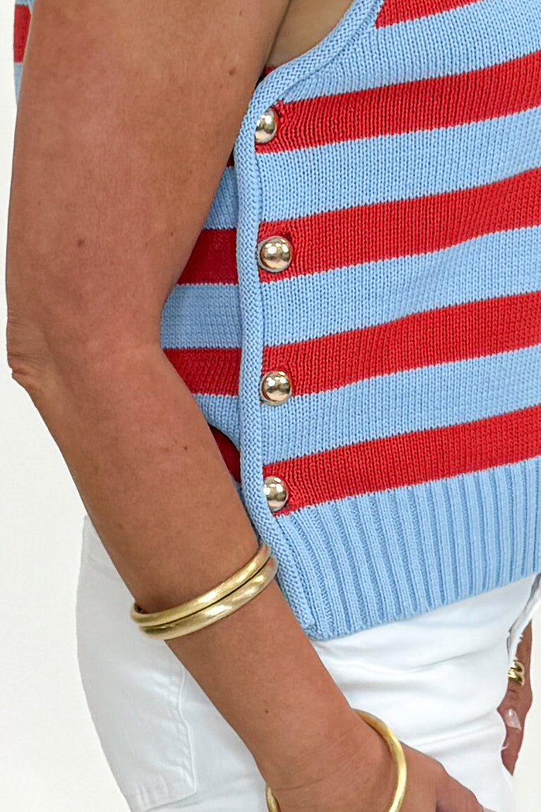 Side detail view of woman wearing Swagger Boutique’s Blue & Red Striped Sleeveless Sweater by Entro with jeans against white studio background.