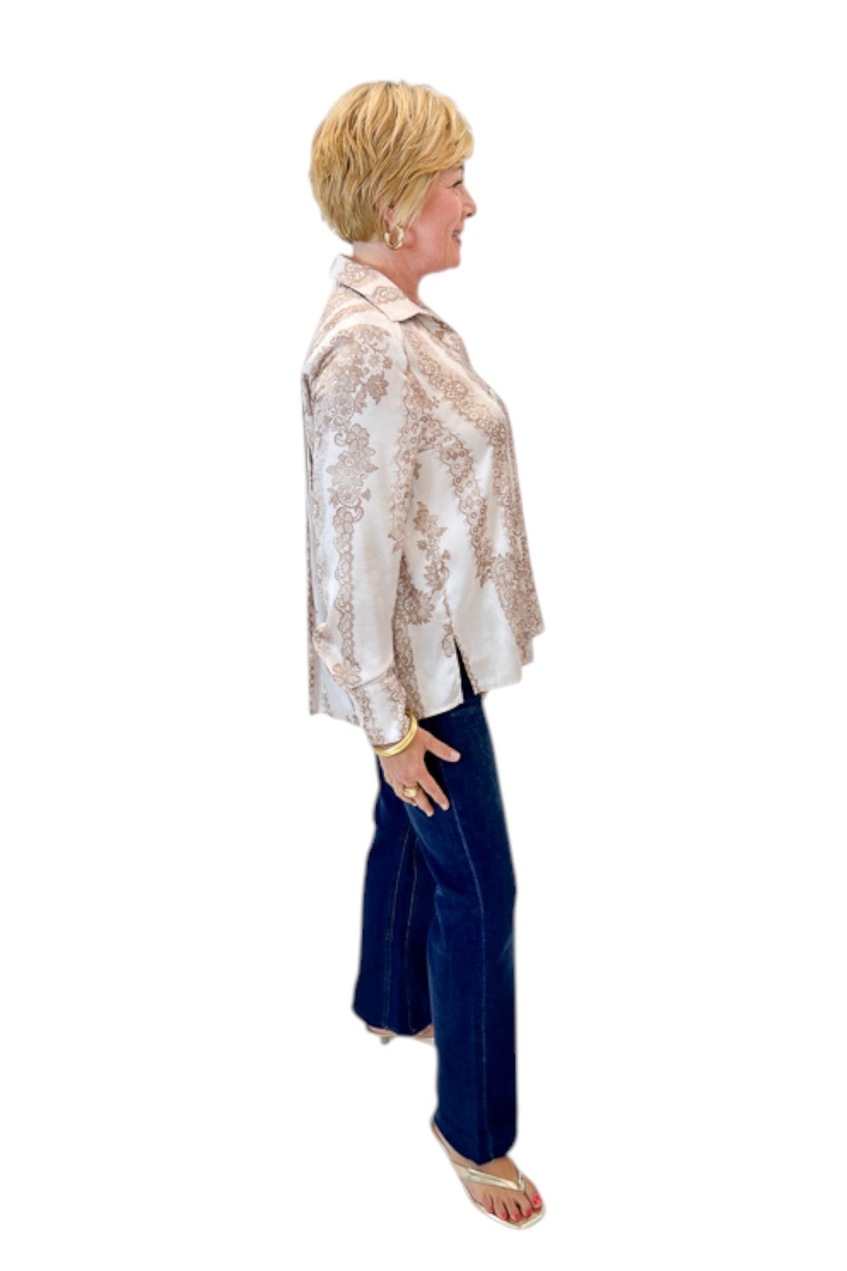Side view of woman wearing Swagger Boutique’s Blush & Tan Lace Print Button Up Top with jeans against white studio background.