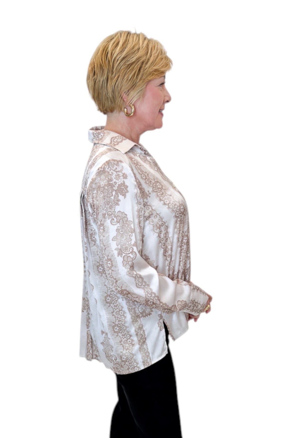 Side view of woman wearing Swagger Boutique’s Blush & Tan Lace Print Button Up Top with jeans against white studio background.