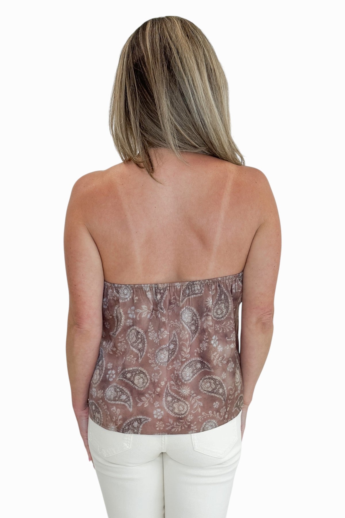 Back view of woman wearing Swagger Boutiqueās Brown Paisley Halter Neck Tank with jeans against white studio background.