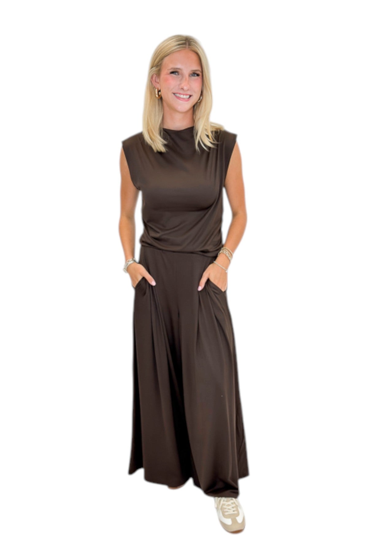Front view of woman wearing Swagger Boutiqueβs Brown Pleated Wide Leg Pants with Brown Rouched Side Tank against white studio background.