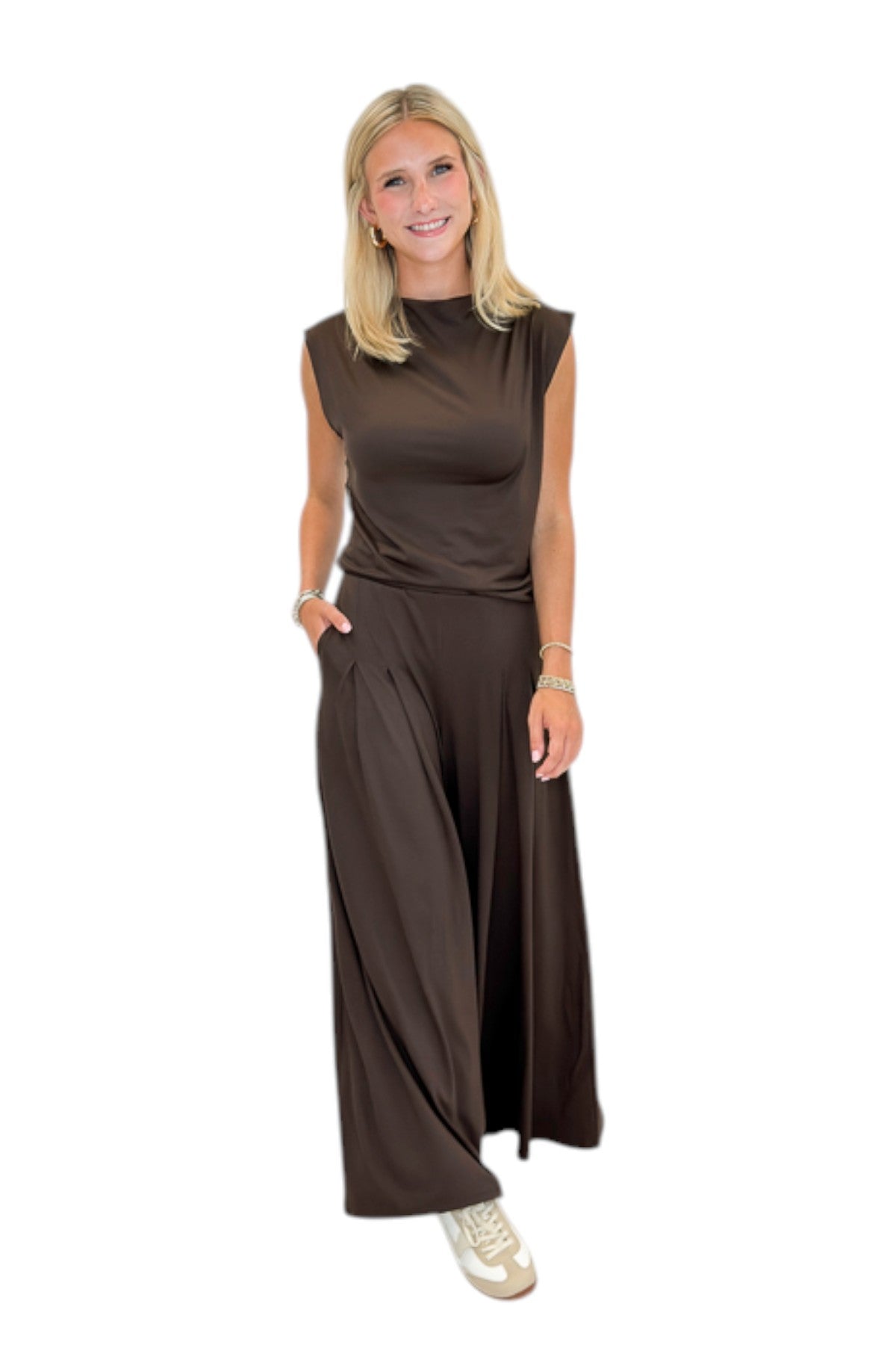 Front view of woman wearing Swagger Boutiqueβs Brown Pleated Wide Leg Pants with Brown Rouched Side Tank against white studio background.
