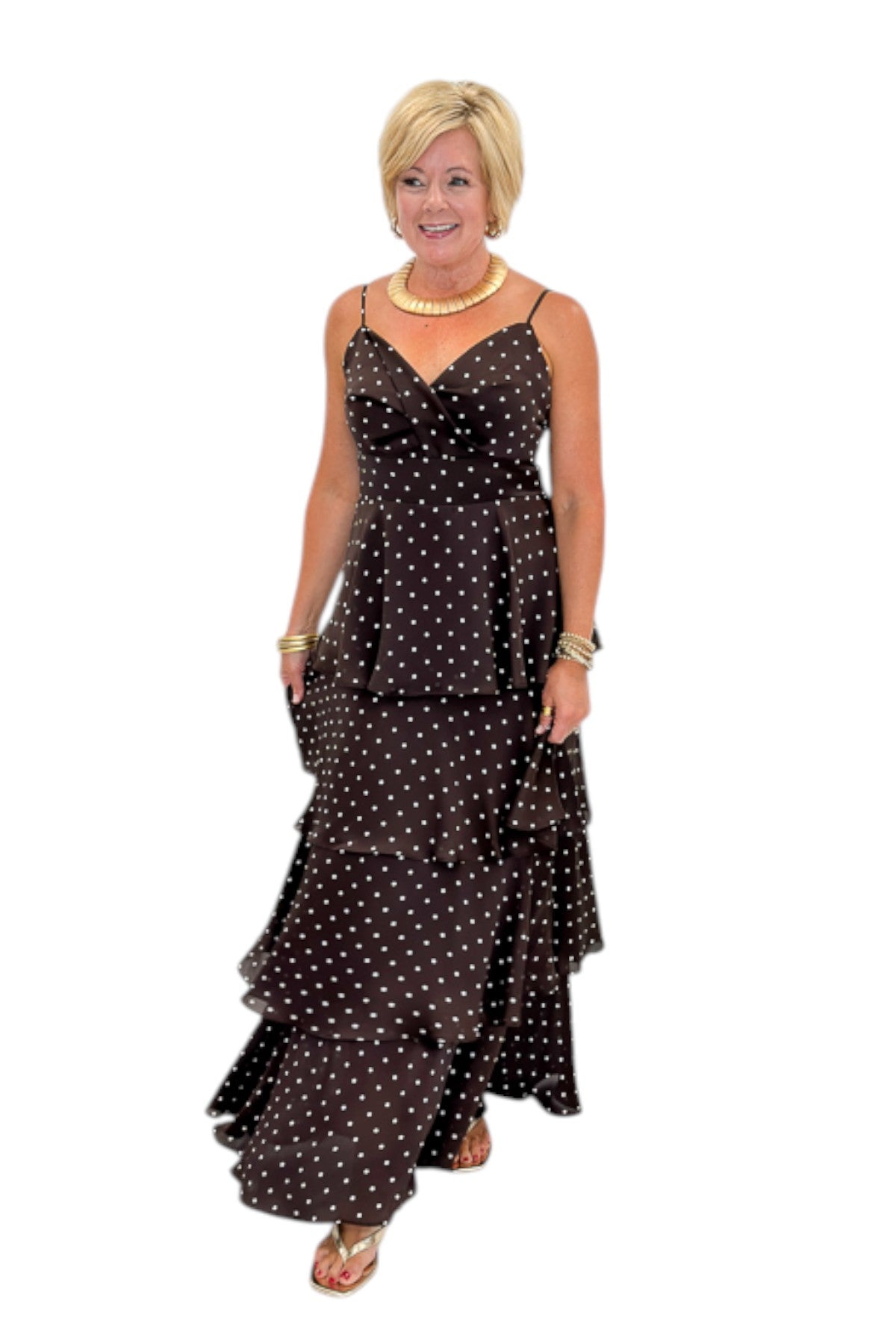 Front view of woman wearing Swagger Boutique’s Brown Polka Dot Tiered Maxi Dress with heels against white studio background.
