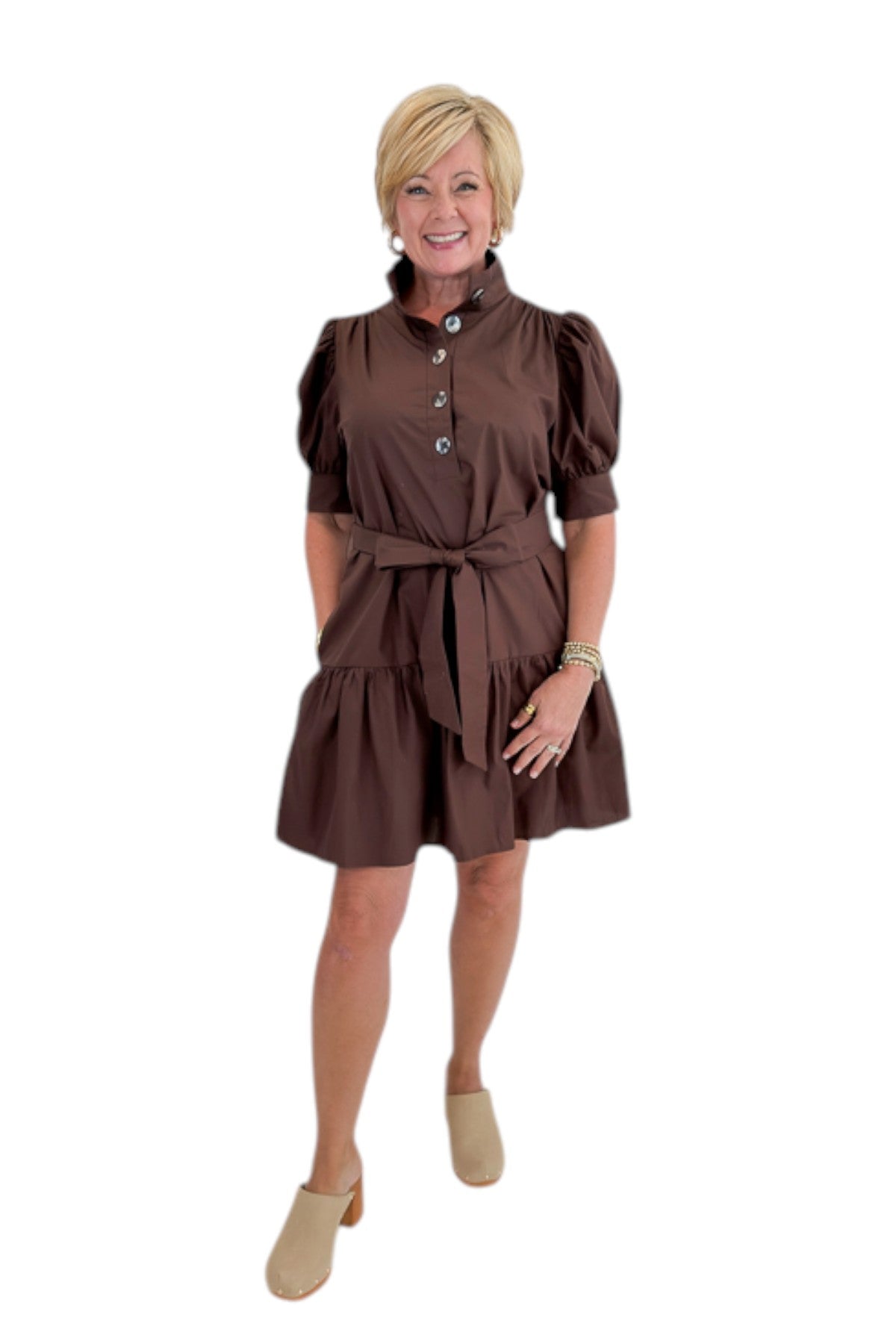 Front view of woman wearing Swagger Boutique’s Brown Ruffle Mini Dress by Entro against white studio background.