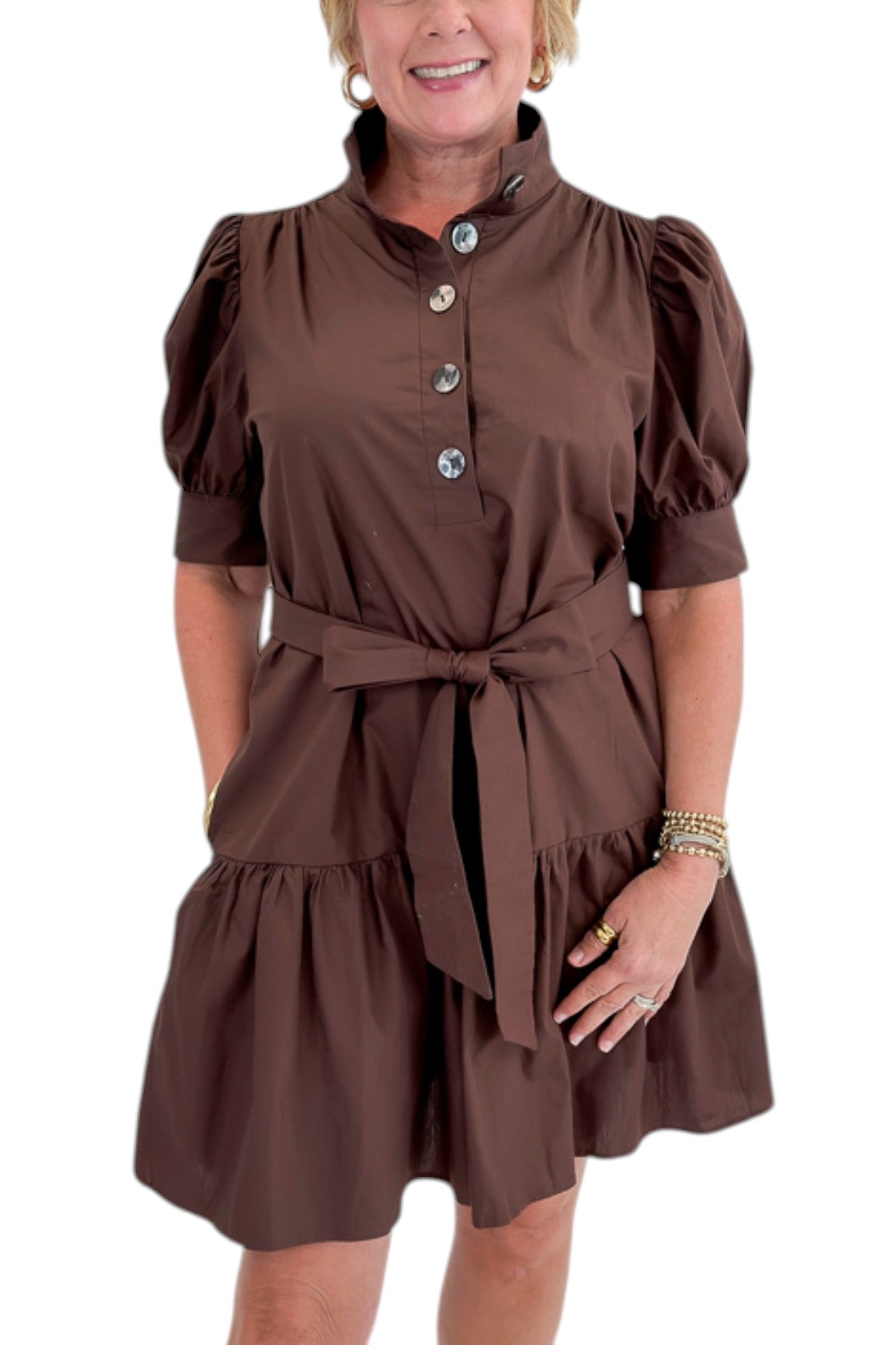 Front detail view of woman wearing Swagger Boutique’s Brown Ruffle Mini Dress by Entro against white studio background.