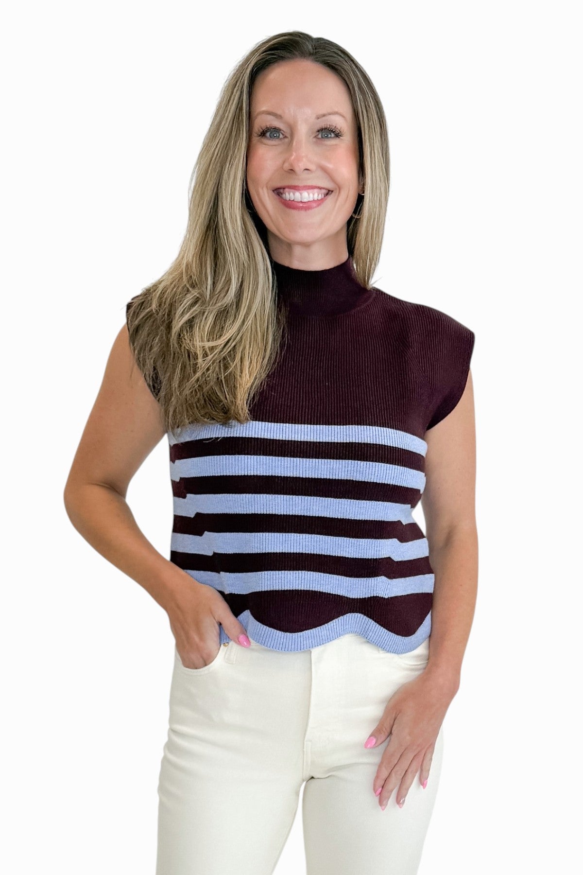 Front view of woman wearing Swagger Boutiqueās Brown & Blue Scallop Hem Sleeveless Sweater by Entro with jeans against white studio background.