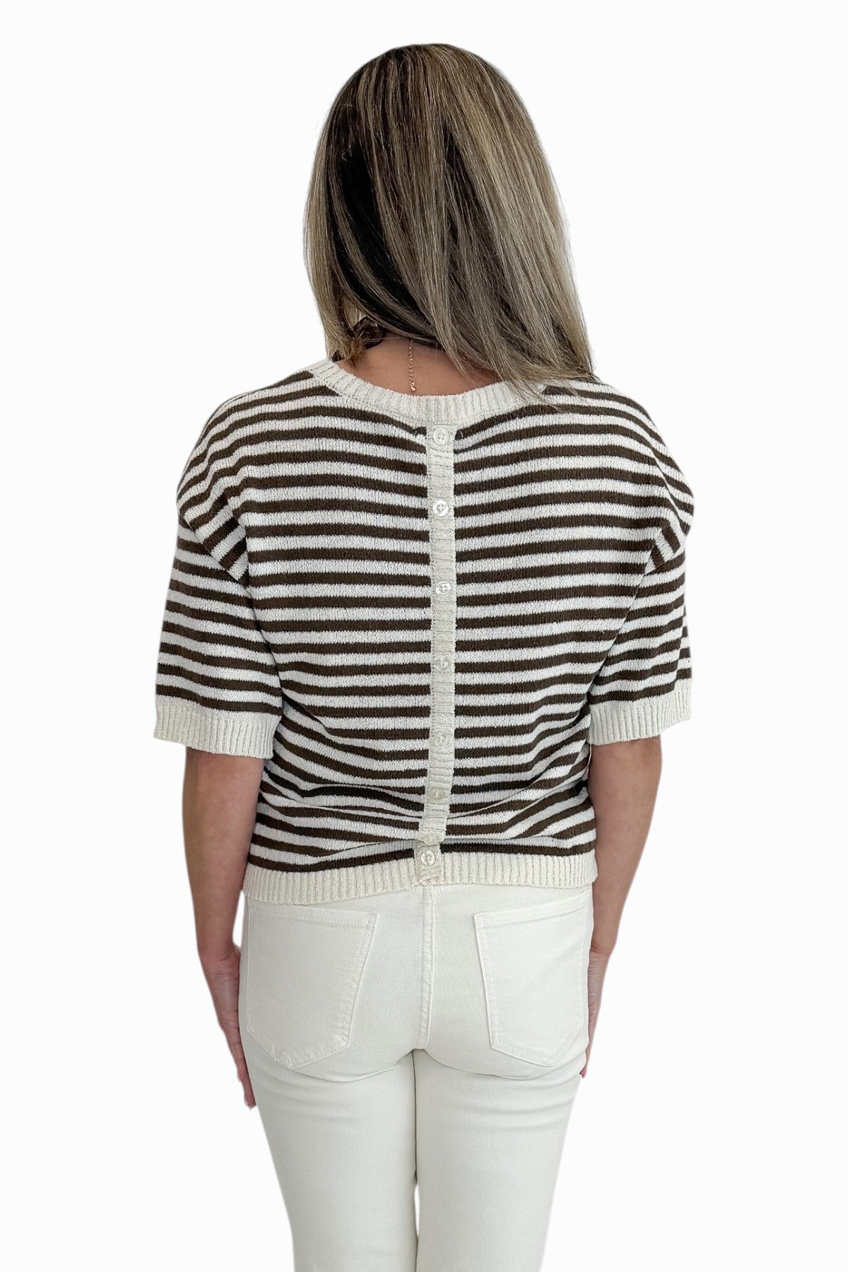 Back view of woman wearing Swagger Boutiqueās Brown & Cream Striped Short Sleeve Sweater with jeans against white studio background.